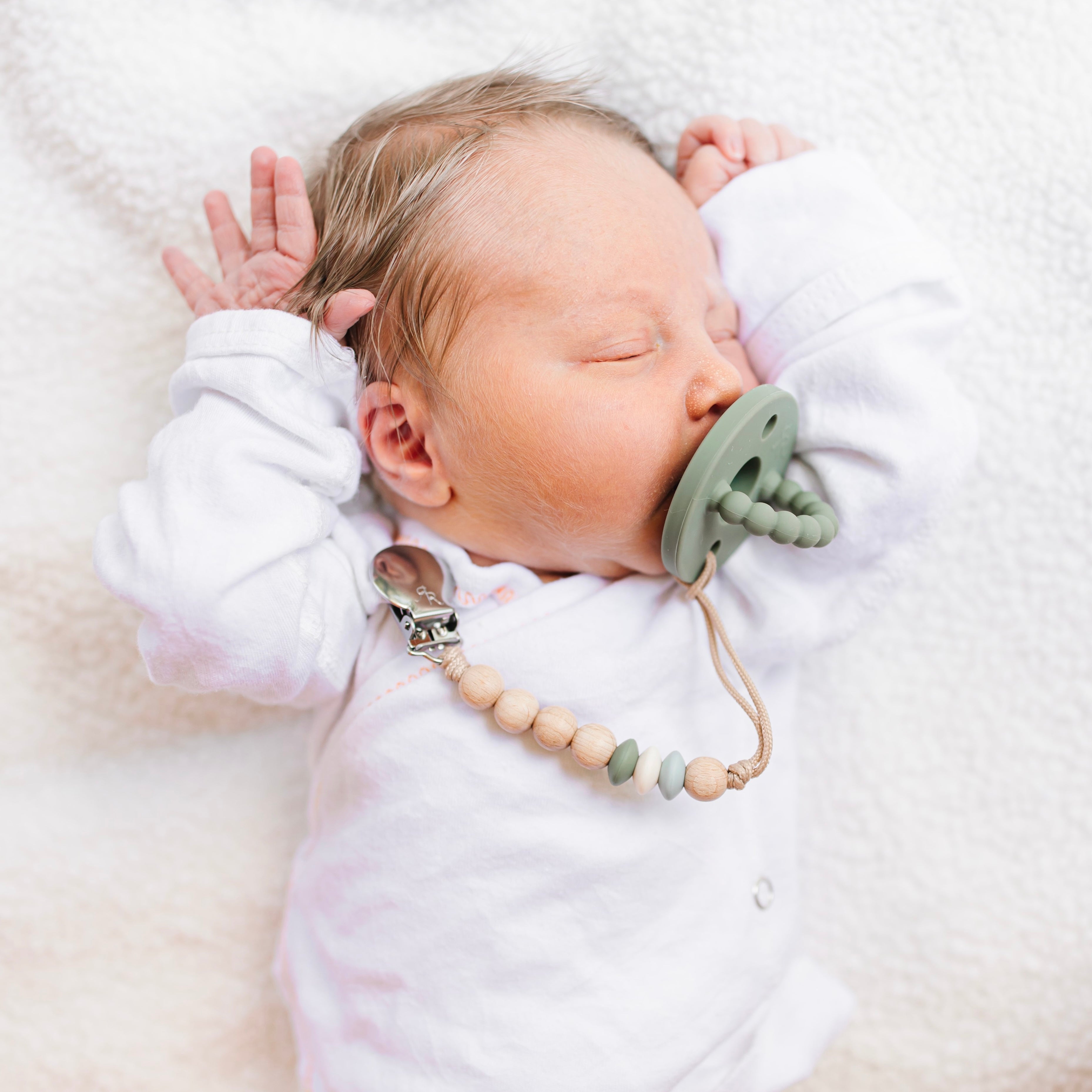Baby sucking on a pacifier