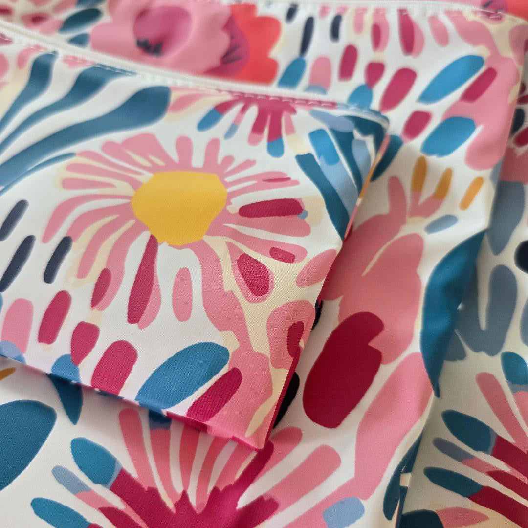Colorful floral-patterned fabric with pink, blue, and yellow flowers.