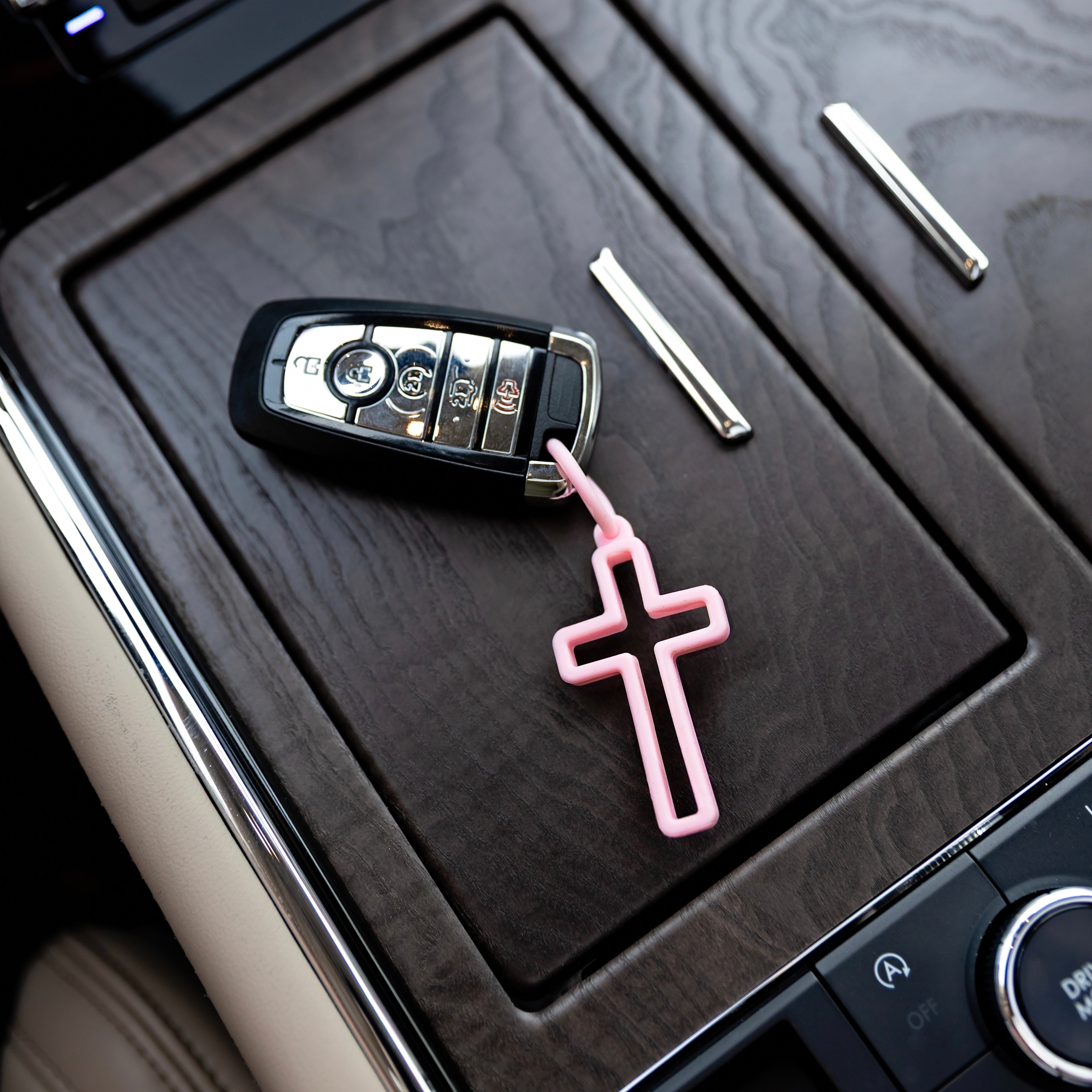 Cross charm attached to key fob