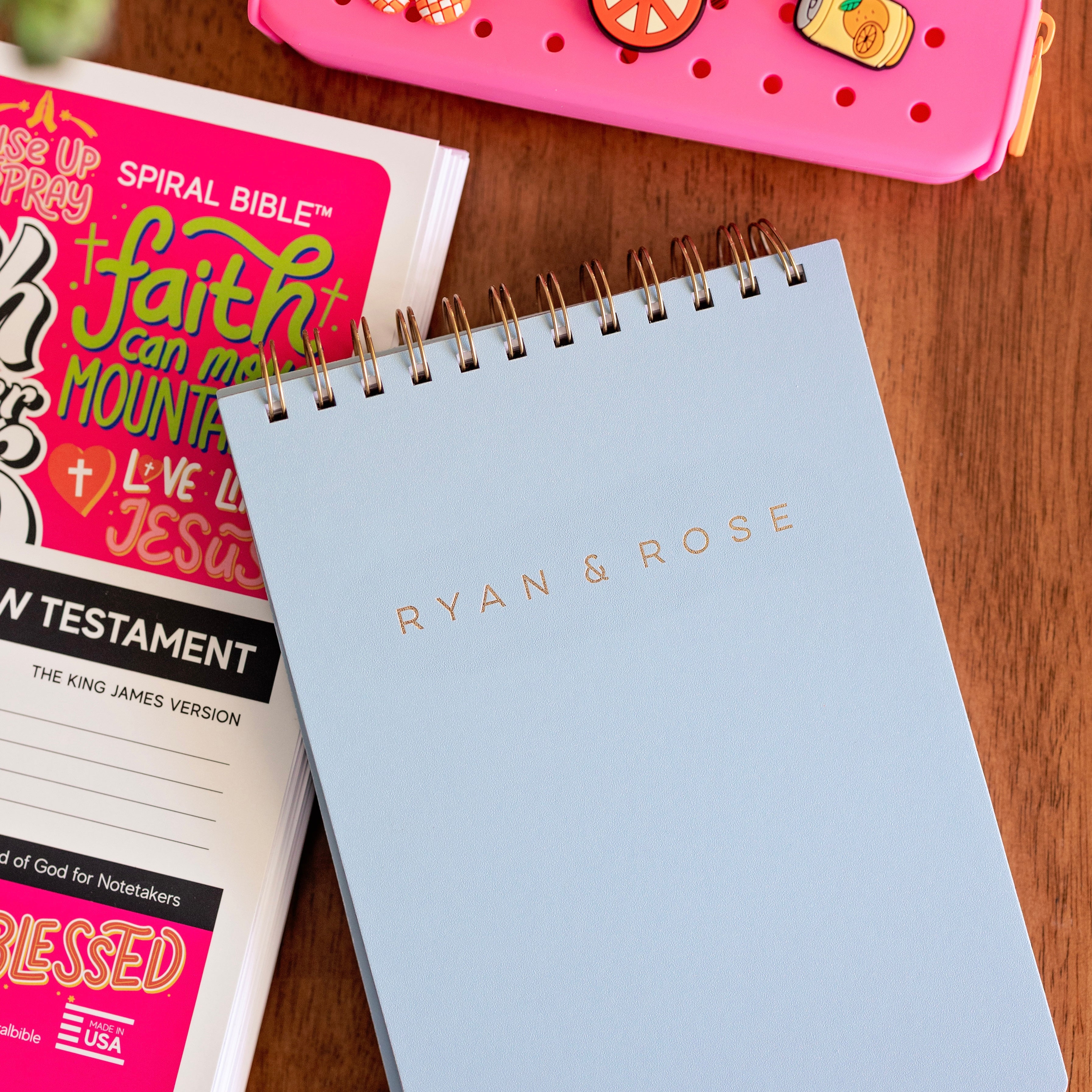 Light blue spiral-bound notebook with &