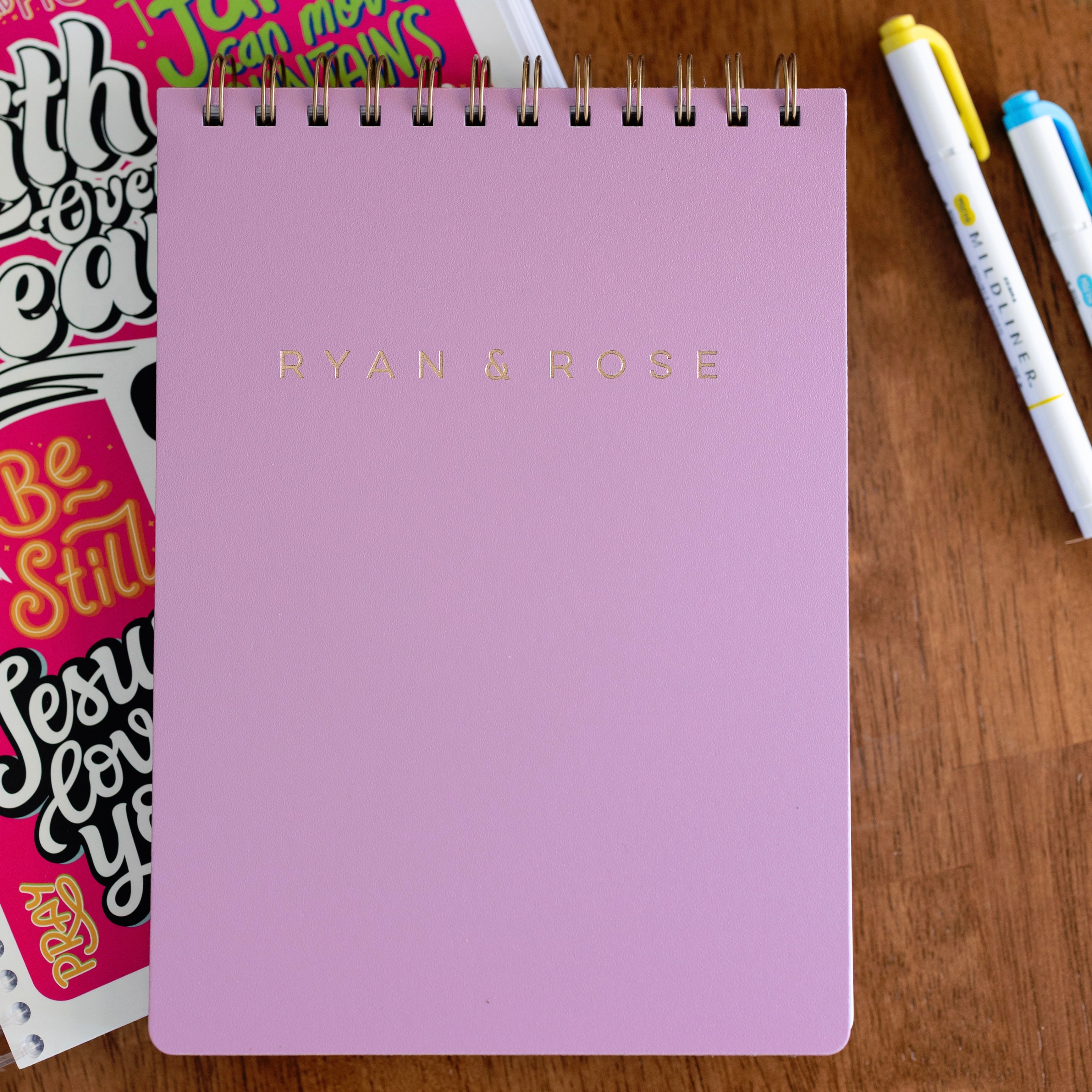 Purple notebook with &