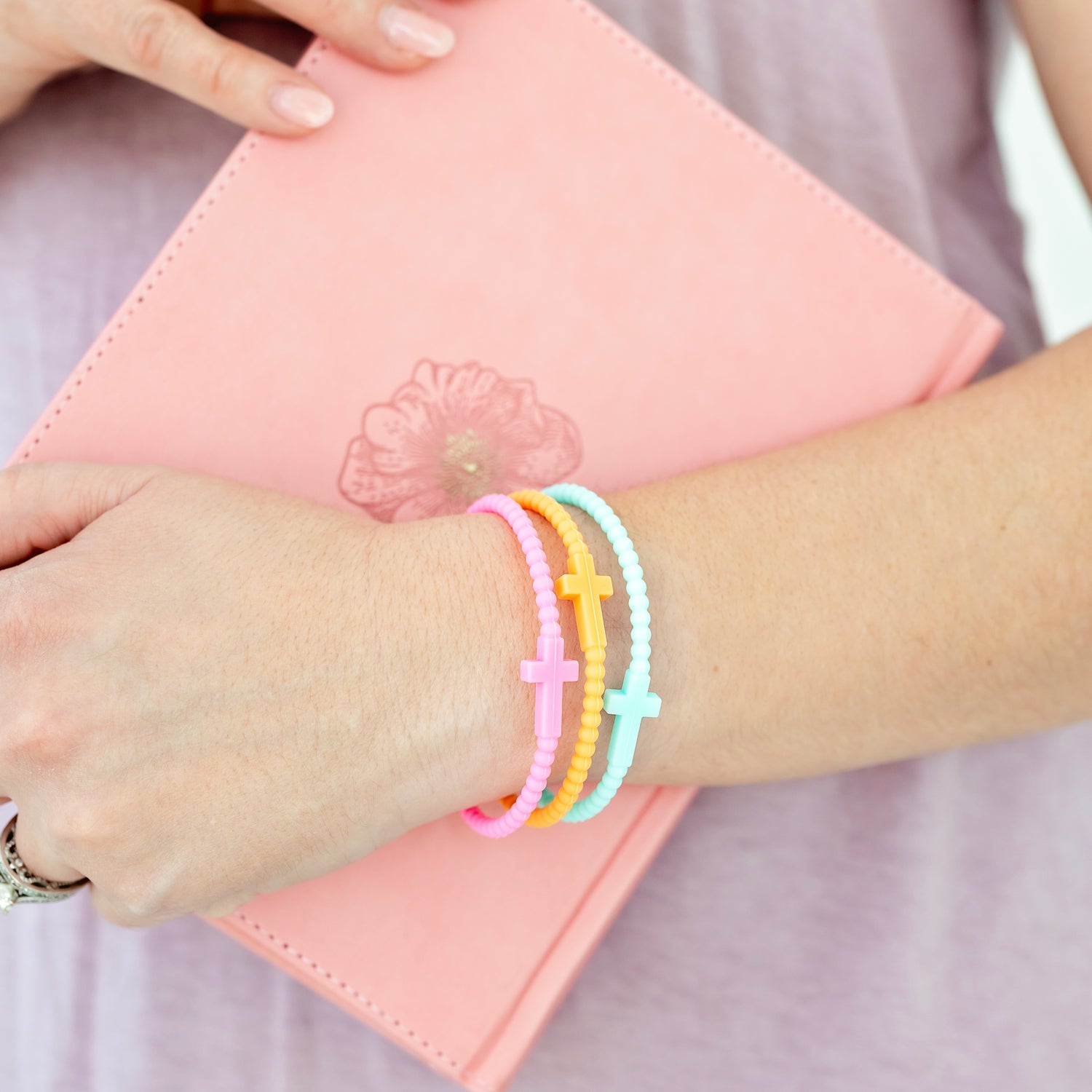 woman wearing Jesus bracelets