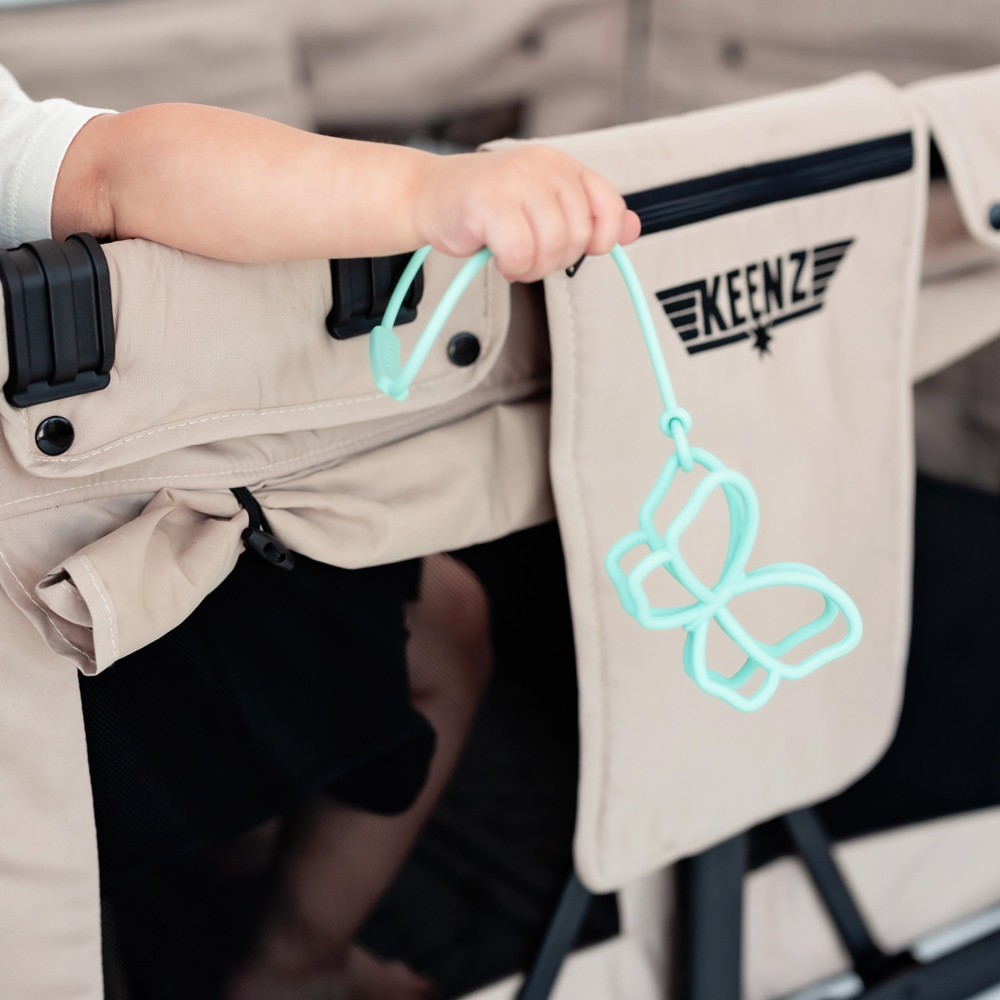 Butterfly teether attached to stroller wagon