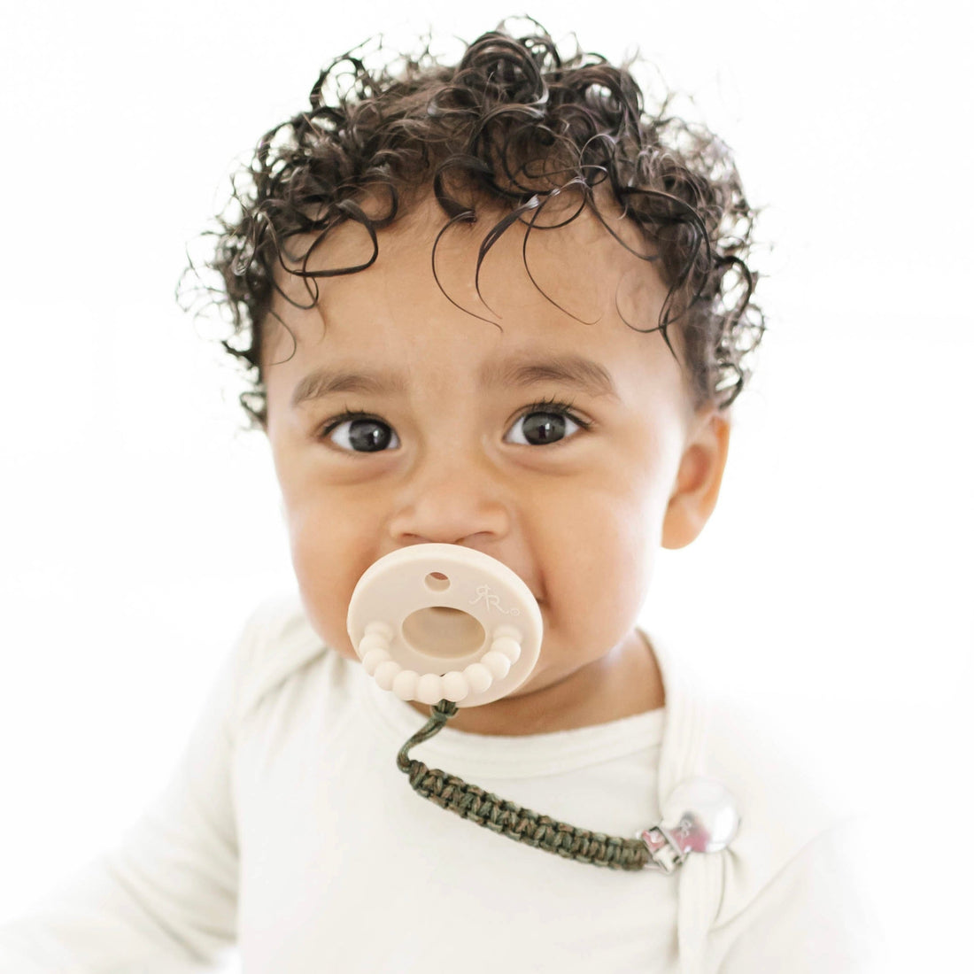 Baby boy wearing a Tan Cutie PAT and Kai Cutie Clip.
