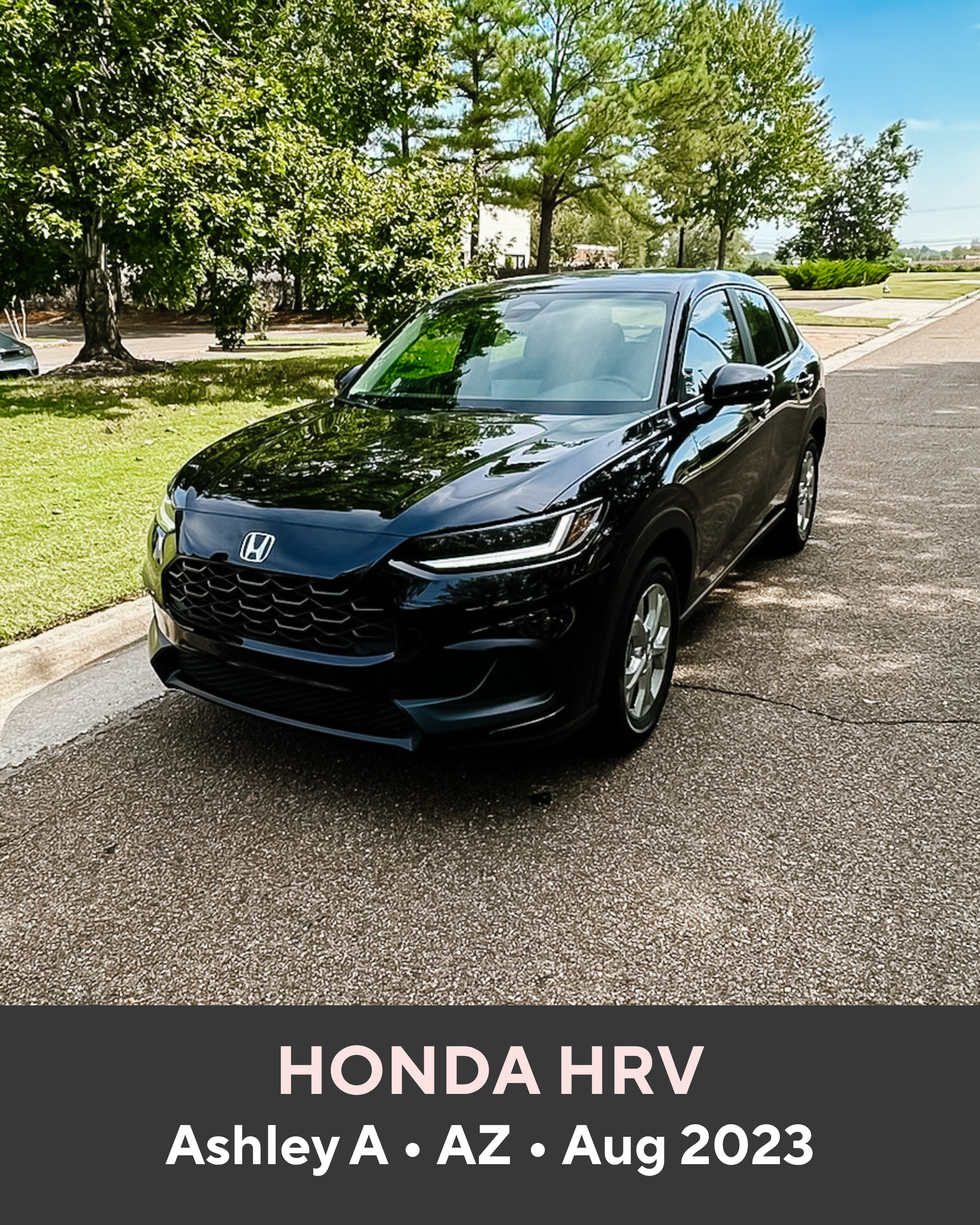 Black Honda HRV parked on a road with trees in the background