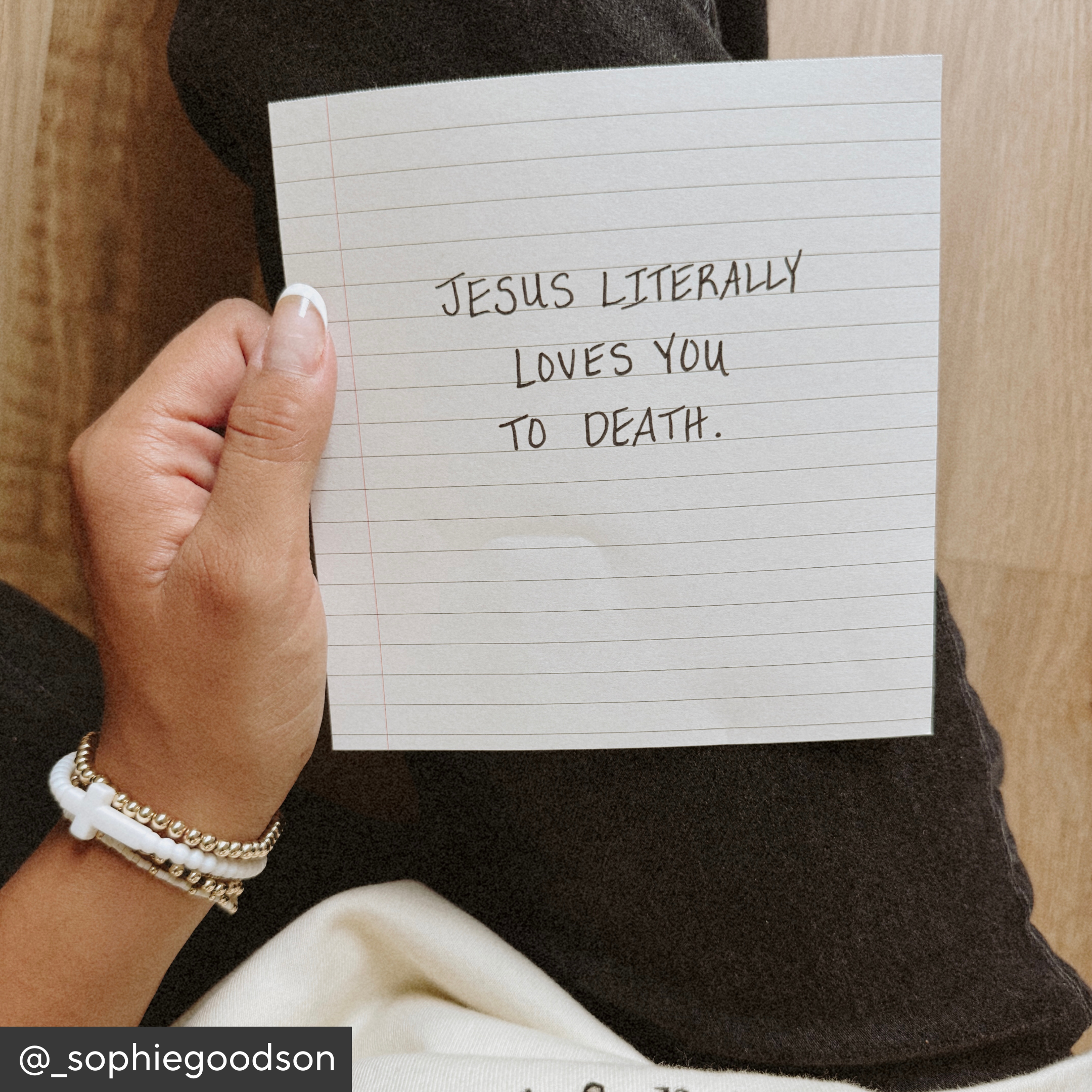 Hand holding a piece of paper with text &