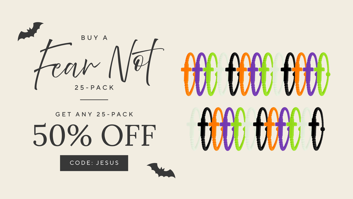 Promotional graphic for a 25-pack of Halloween-themed font designs. The text reads 'BUY A Fear Not 25-PACK GET ANY 25-PACK 50% OFF' with the code 'JESUS' on a black bar, accompanied by bat silhouettes.