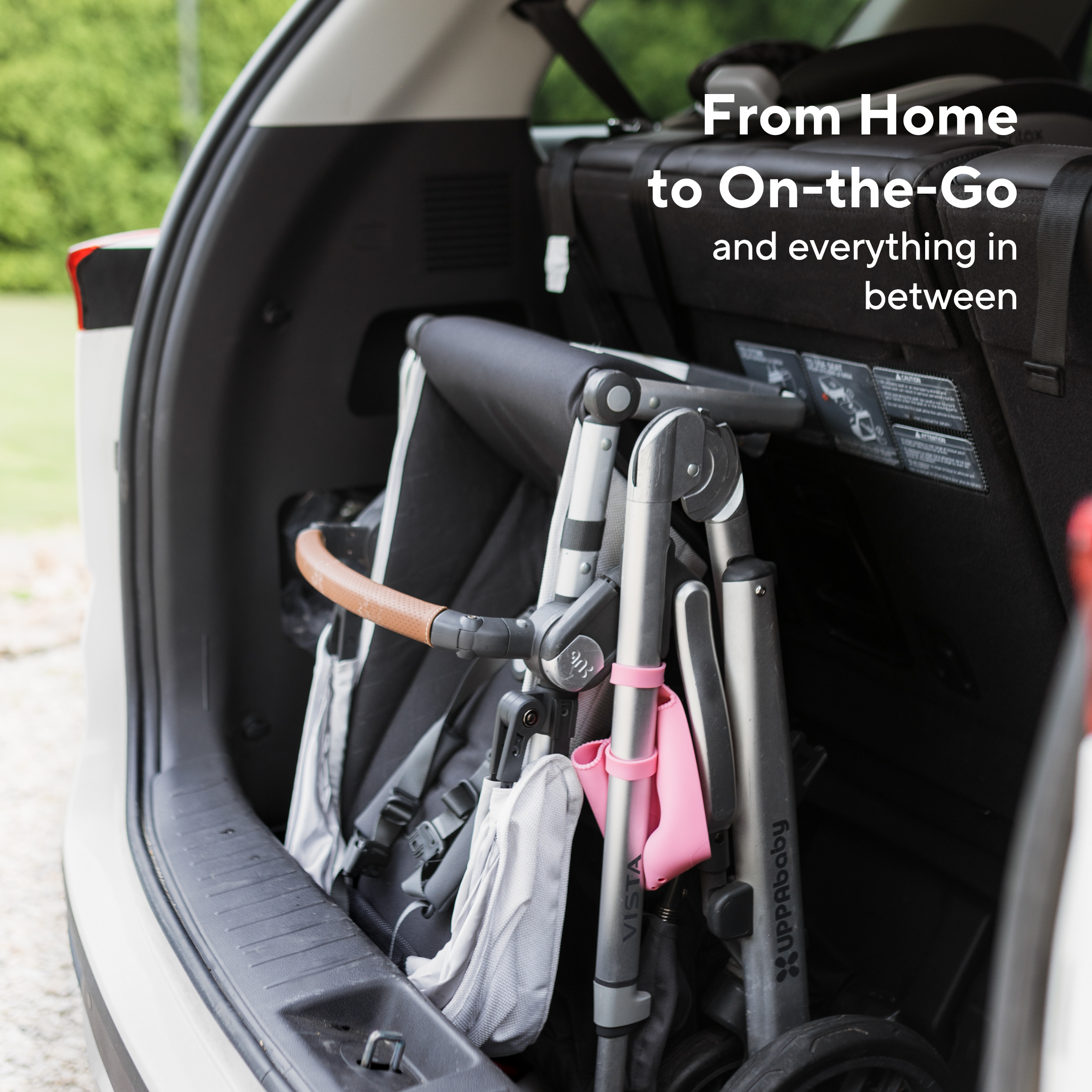 Folded stroller in a car trunk with text &