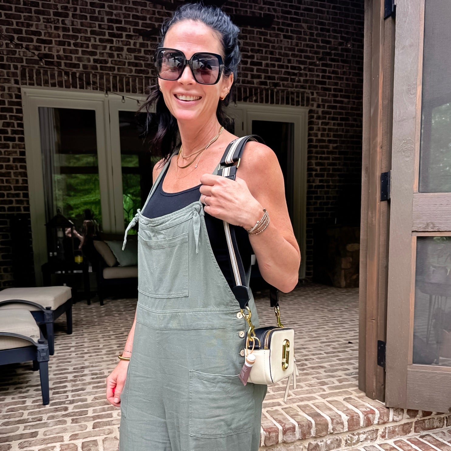 Woman wearing purse with lip balm holder attached