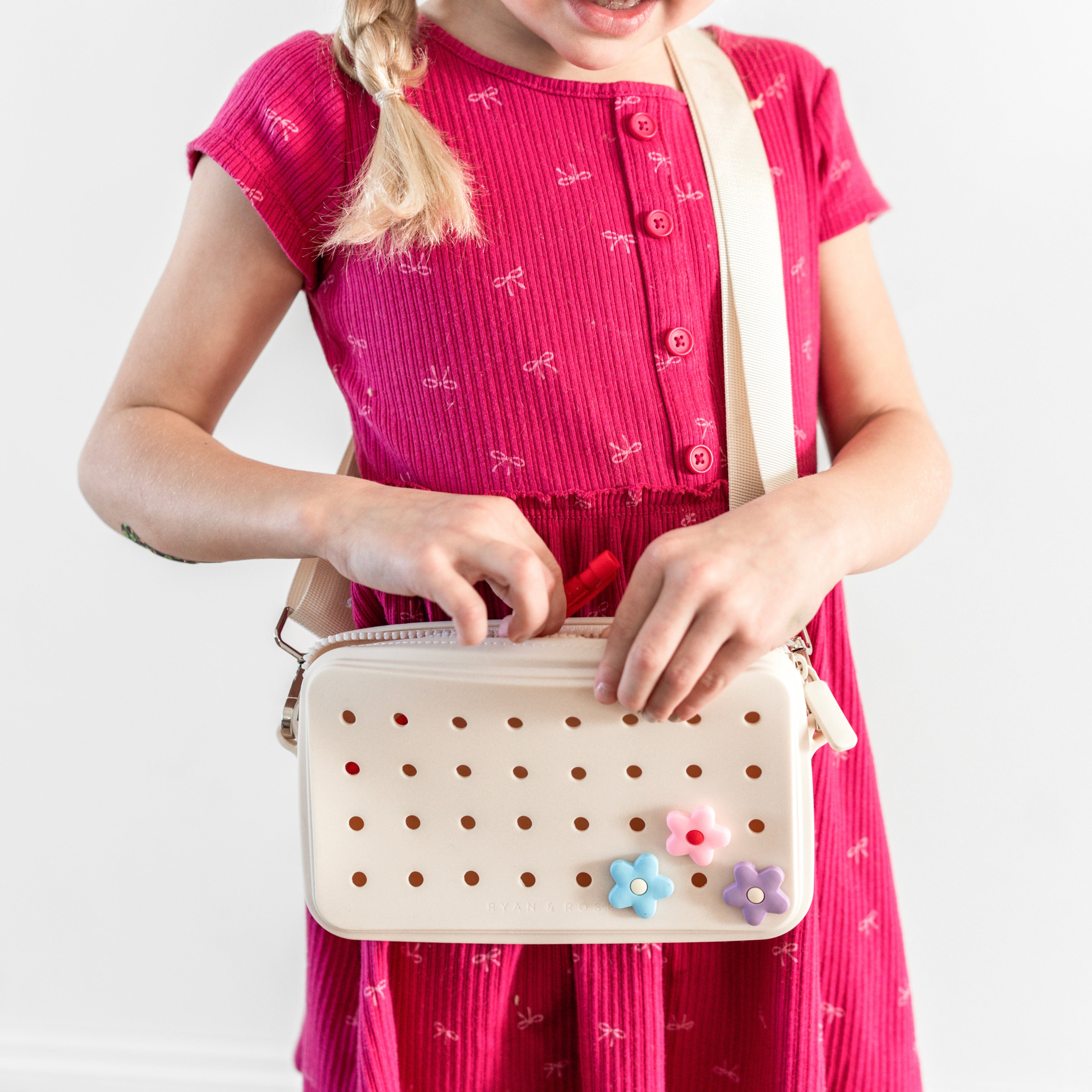 Girl wearing crossbody charm purse