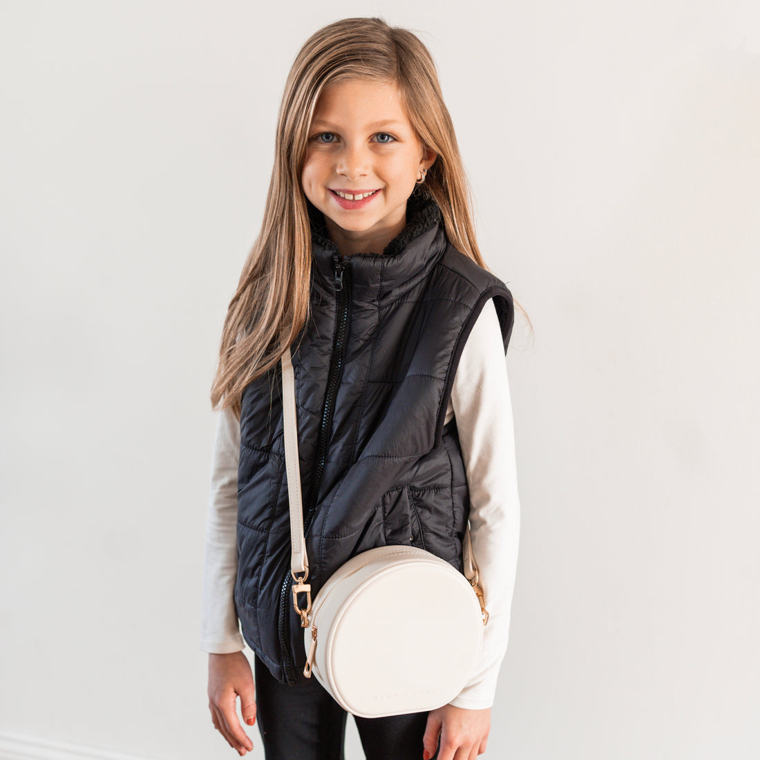 Girl wearing round crossbody purse