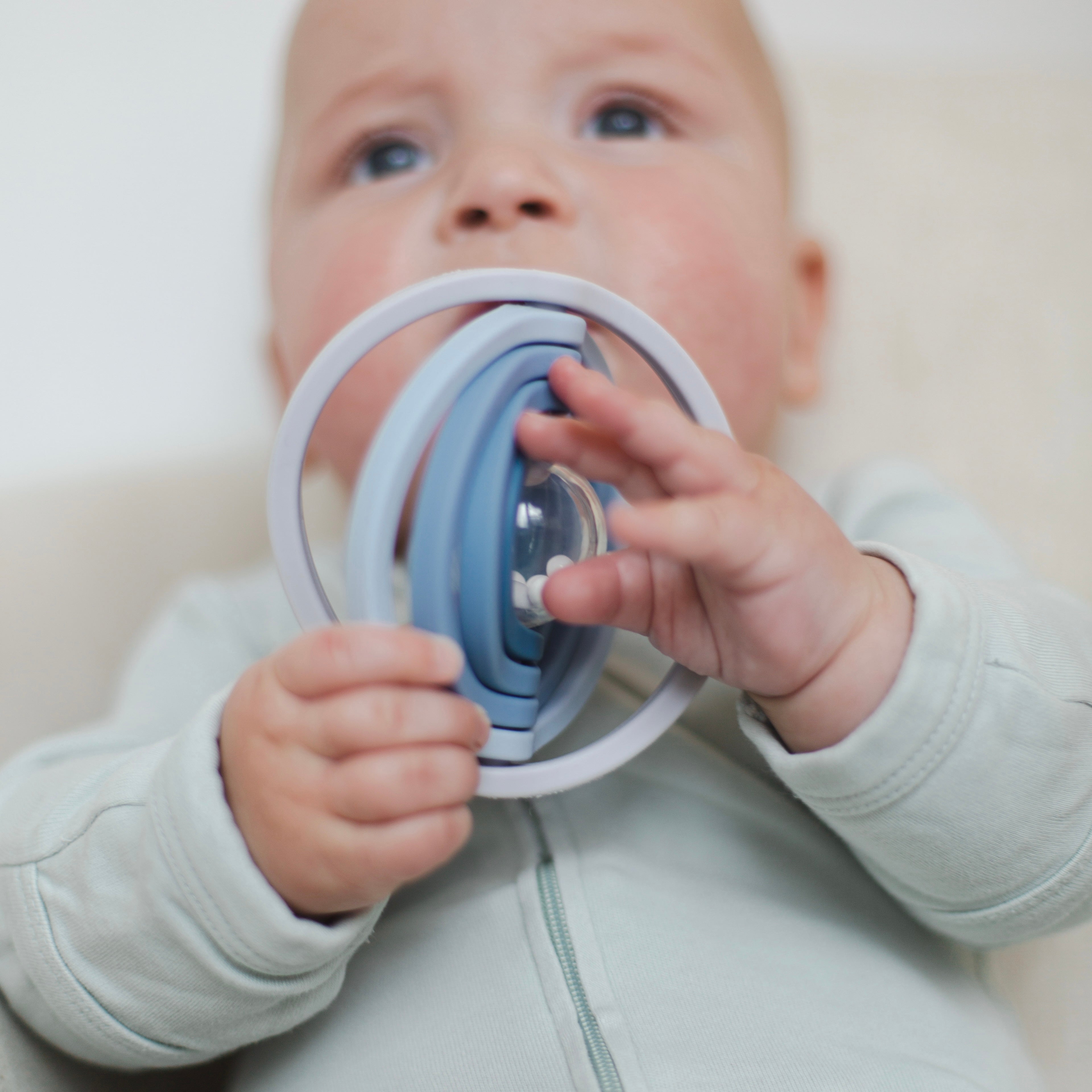 Baby playing with universe rattle toy