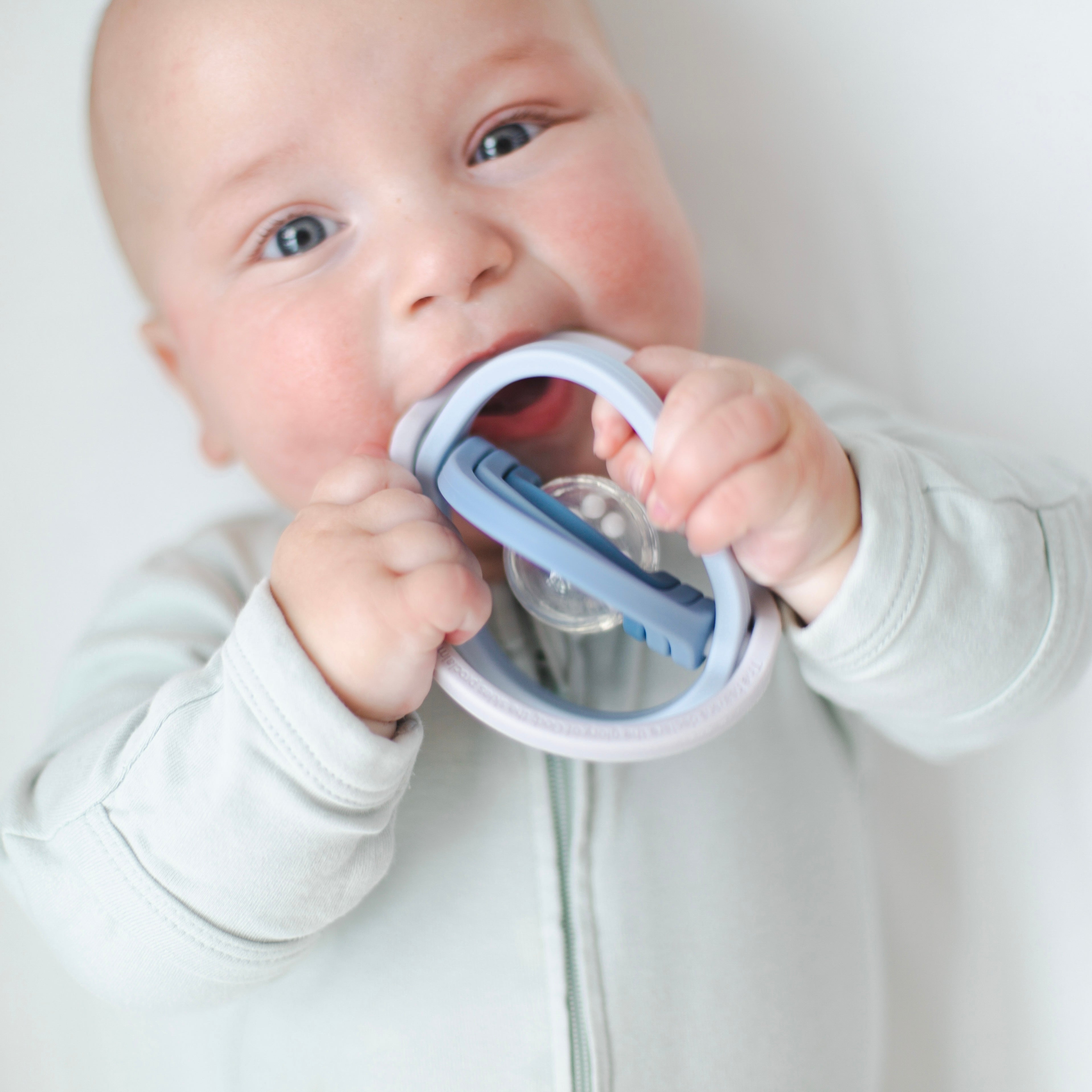 Baby playing with universe rattle toy