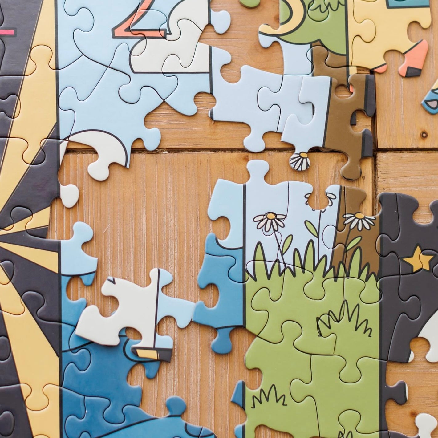 Partial puzzle with cartoon characters on a wooden surface