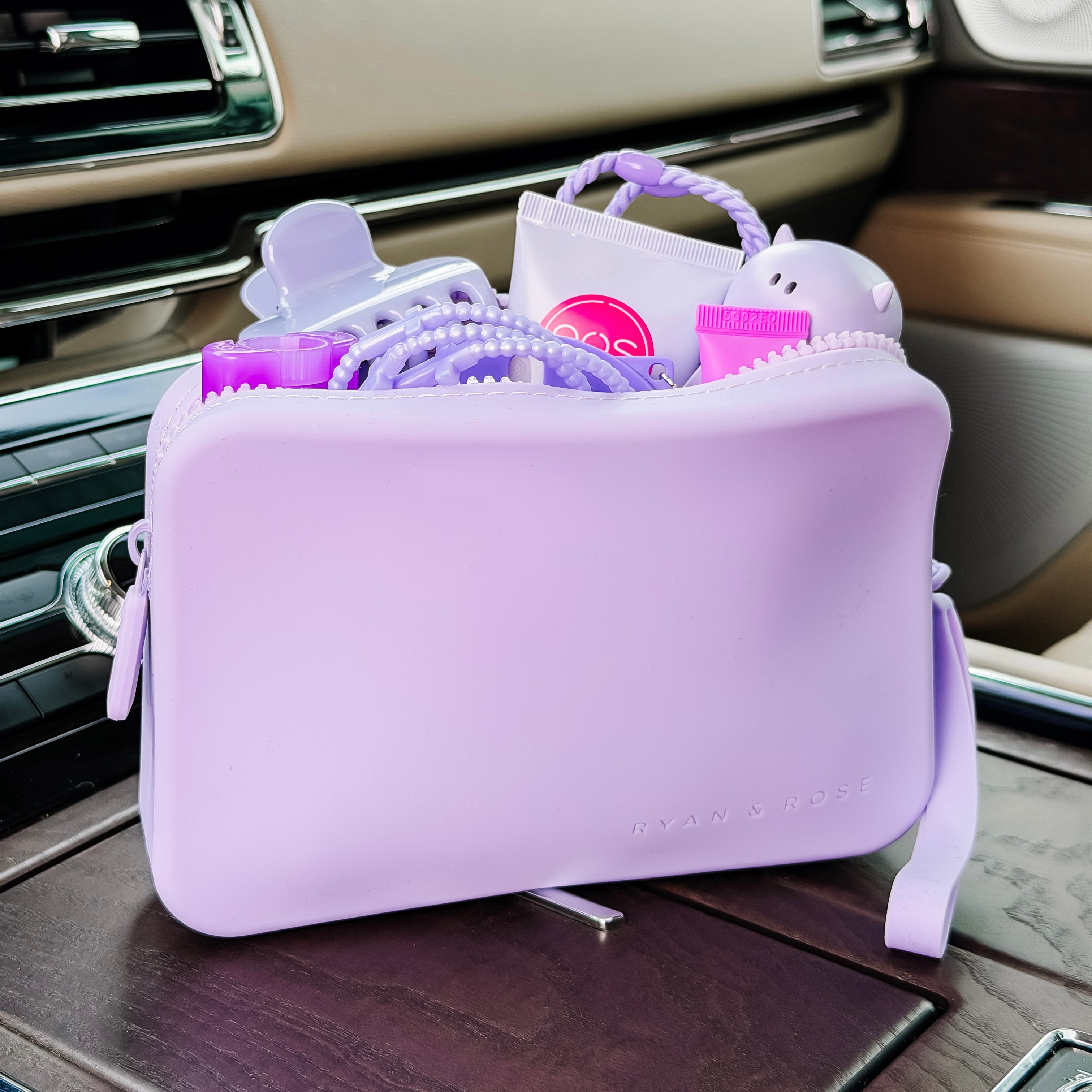 Purple car organizer with baby items on a car seat
