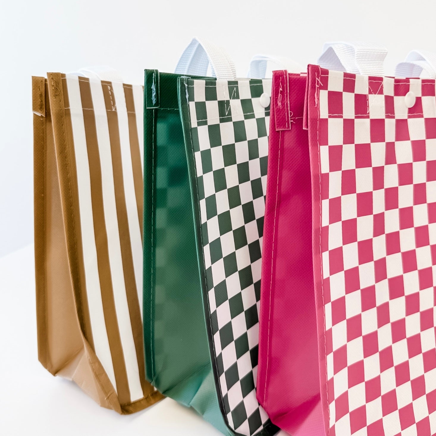 Four colorful paper bags with different patterns on a white background