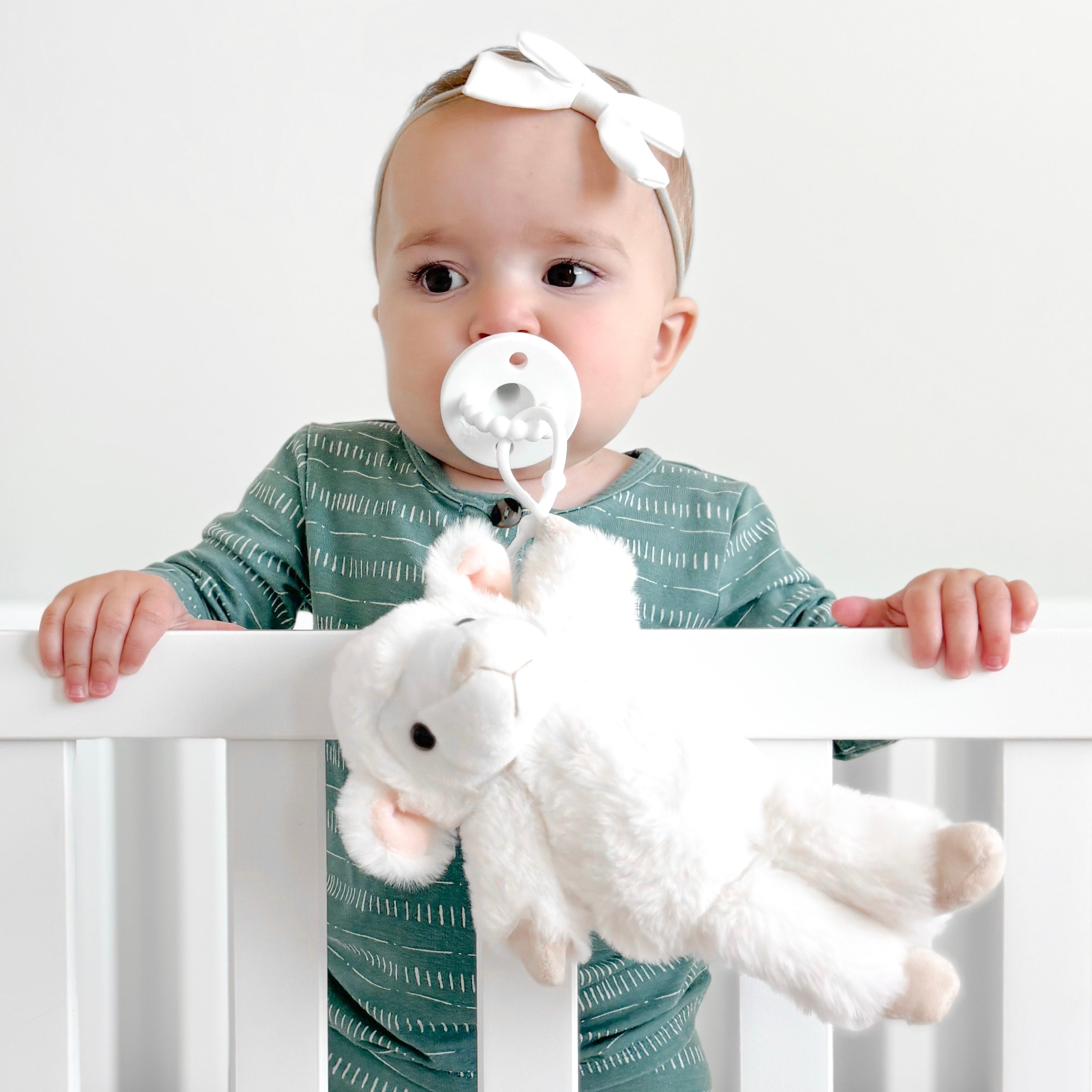 Baby with a lamb cuddle stuffie