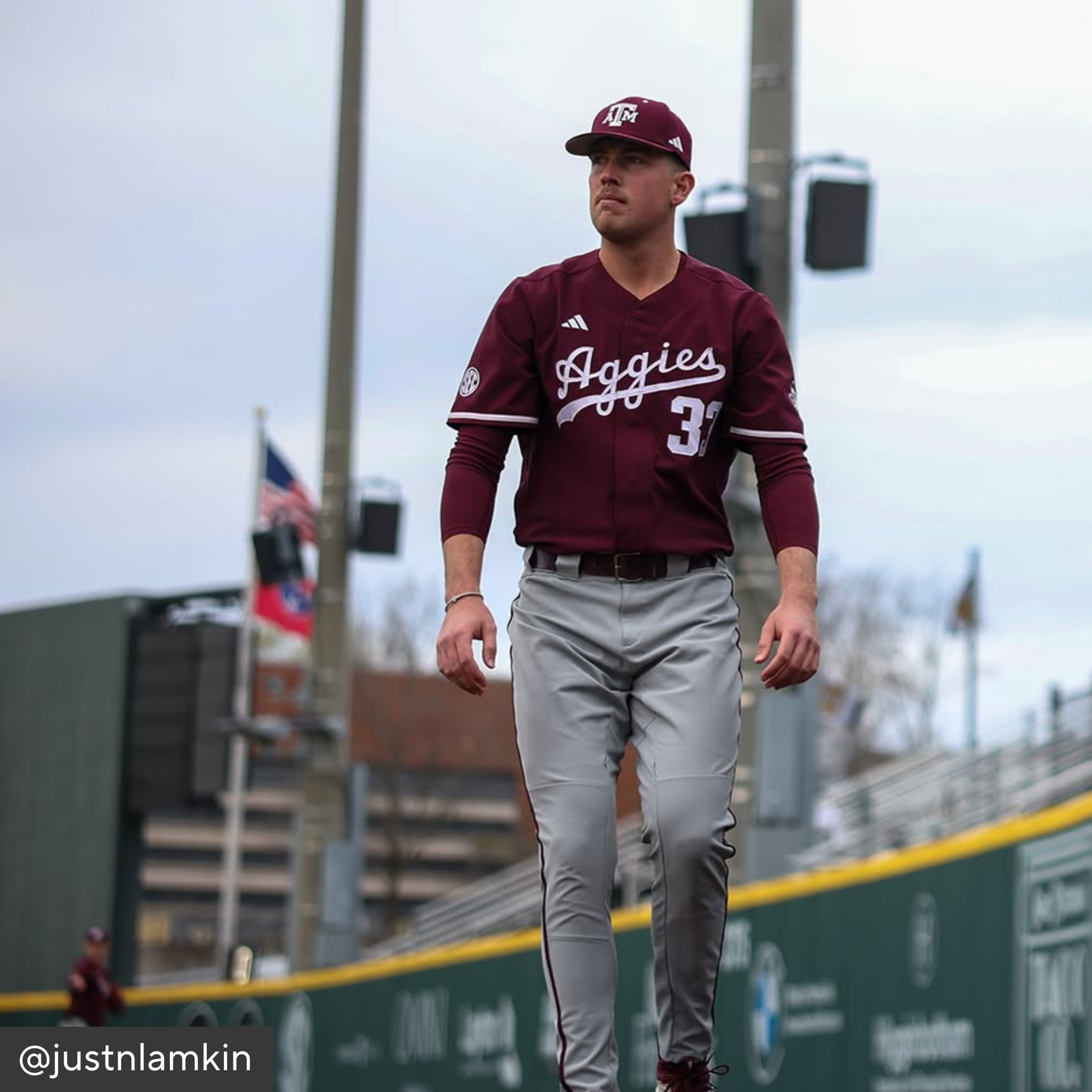 Baseball player in maroon and gray uniform with &