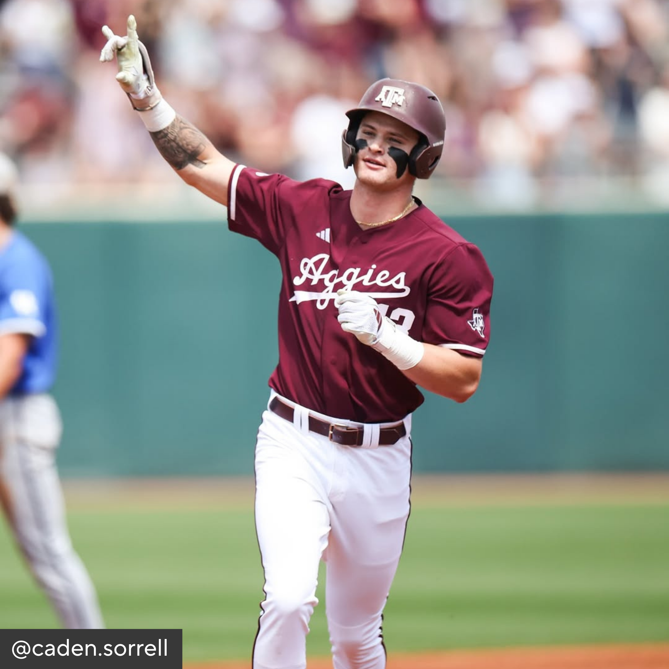 Baseball player in maroon and white uniform with &