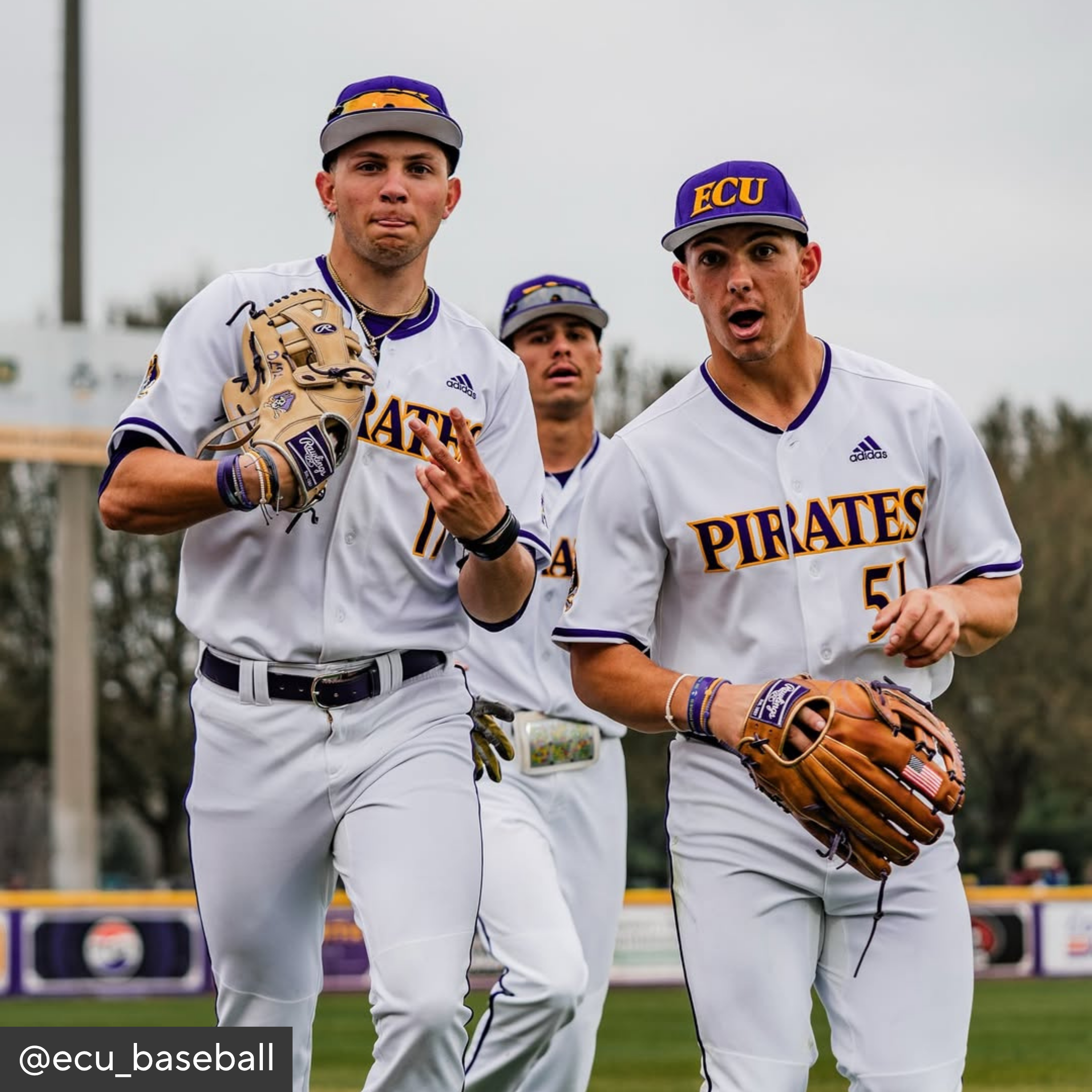 Baseball players in ECU Pirates uniforms on a field