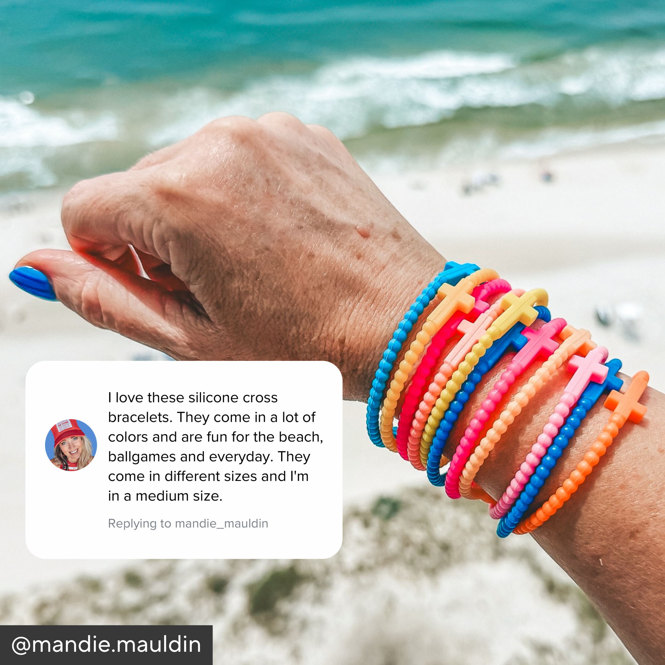 Hand wearing colorful silicone cross bracelets on a beach