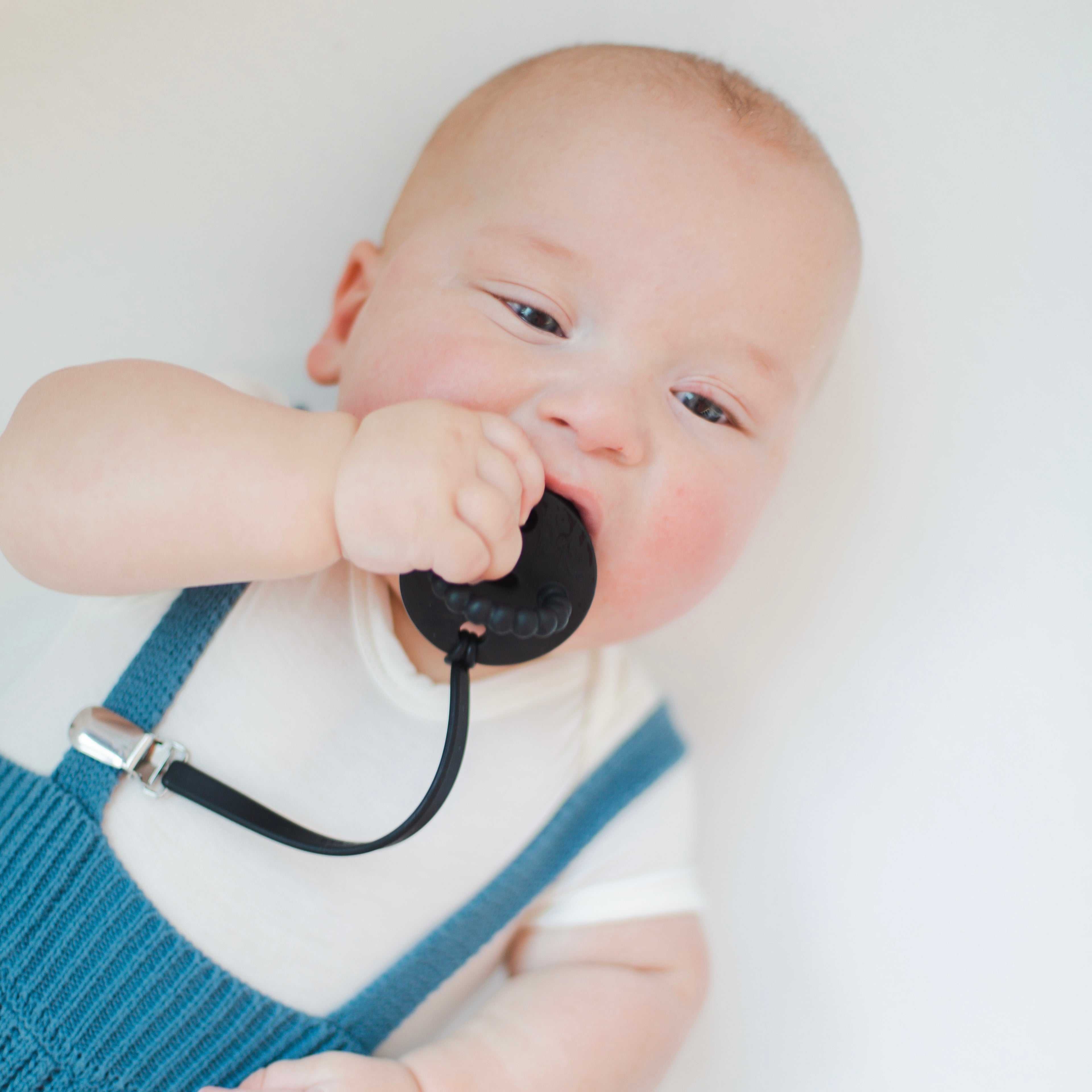 Baby with pacifier clip and teether