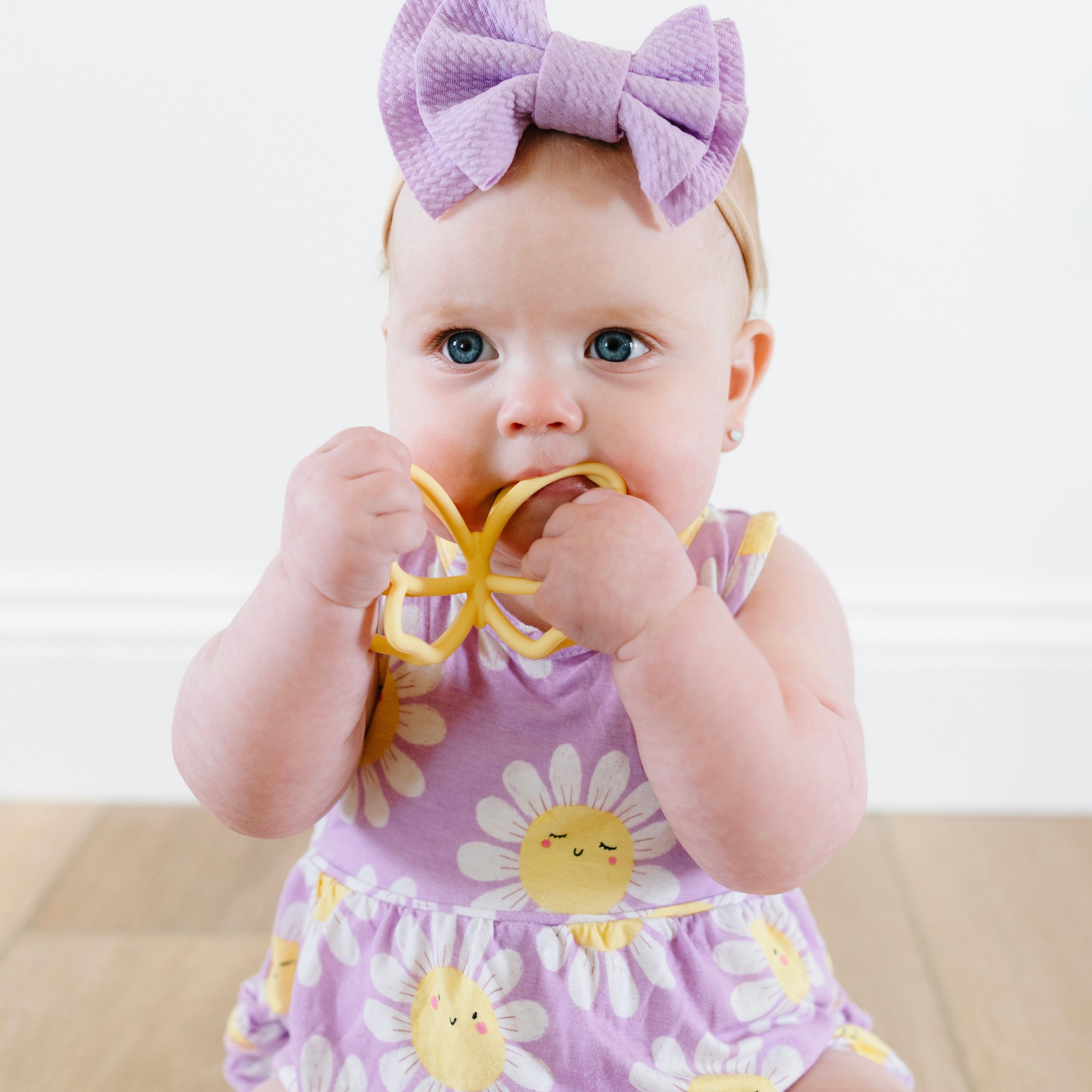 Baby playing with butterfly teether