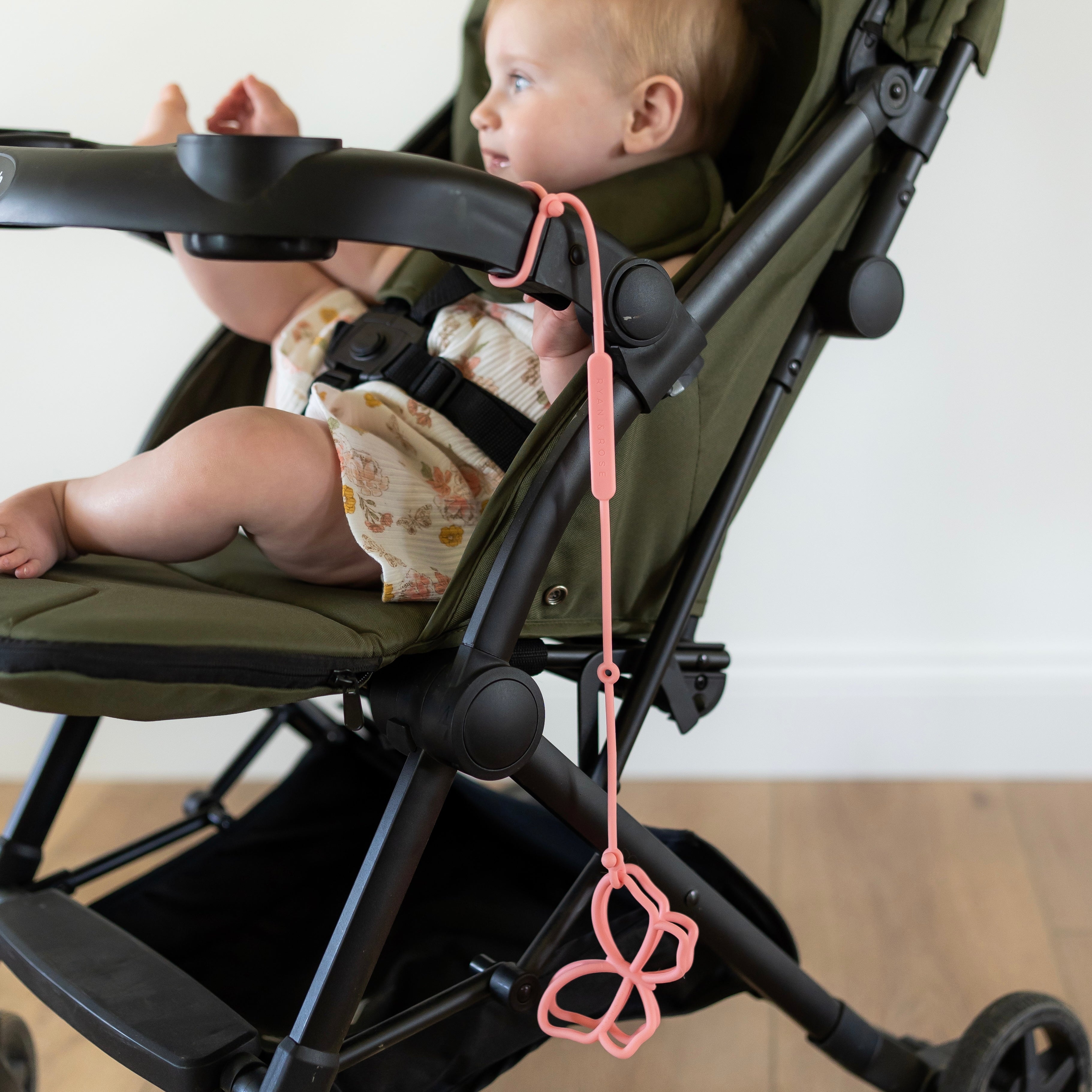 Butterfly teether attached to stroller