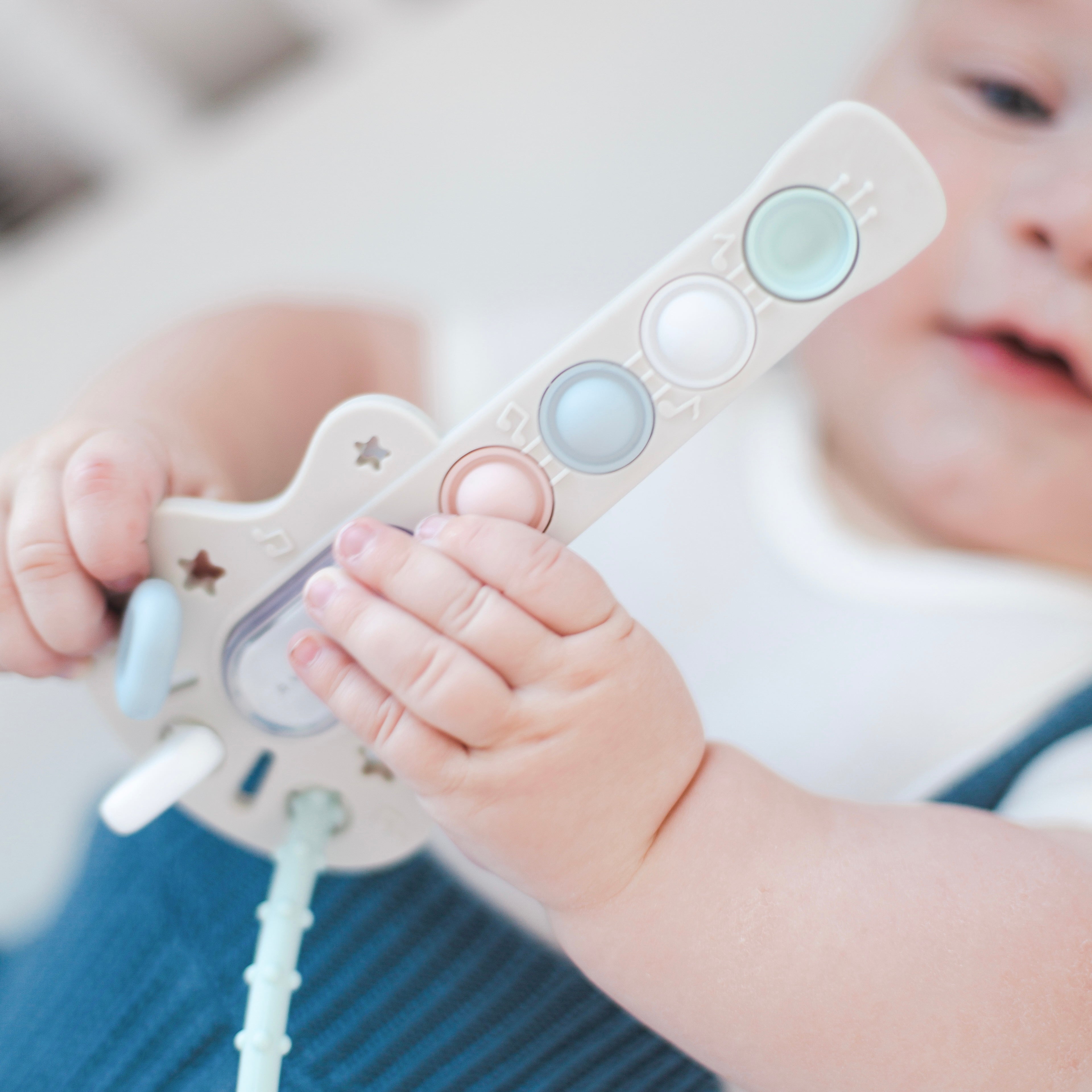 Baby playing with guitar toy