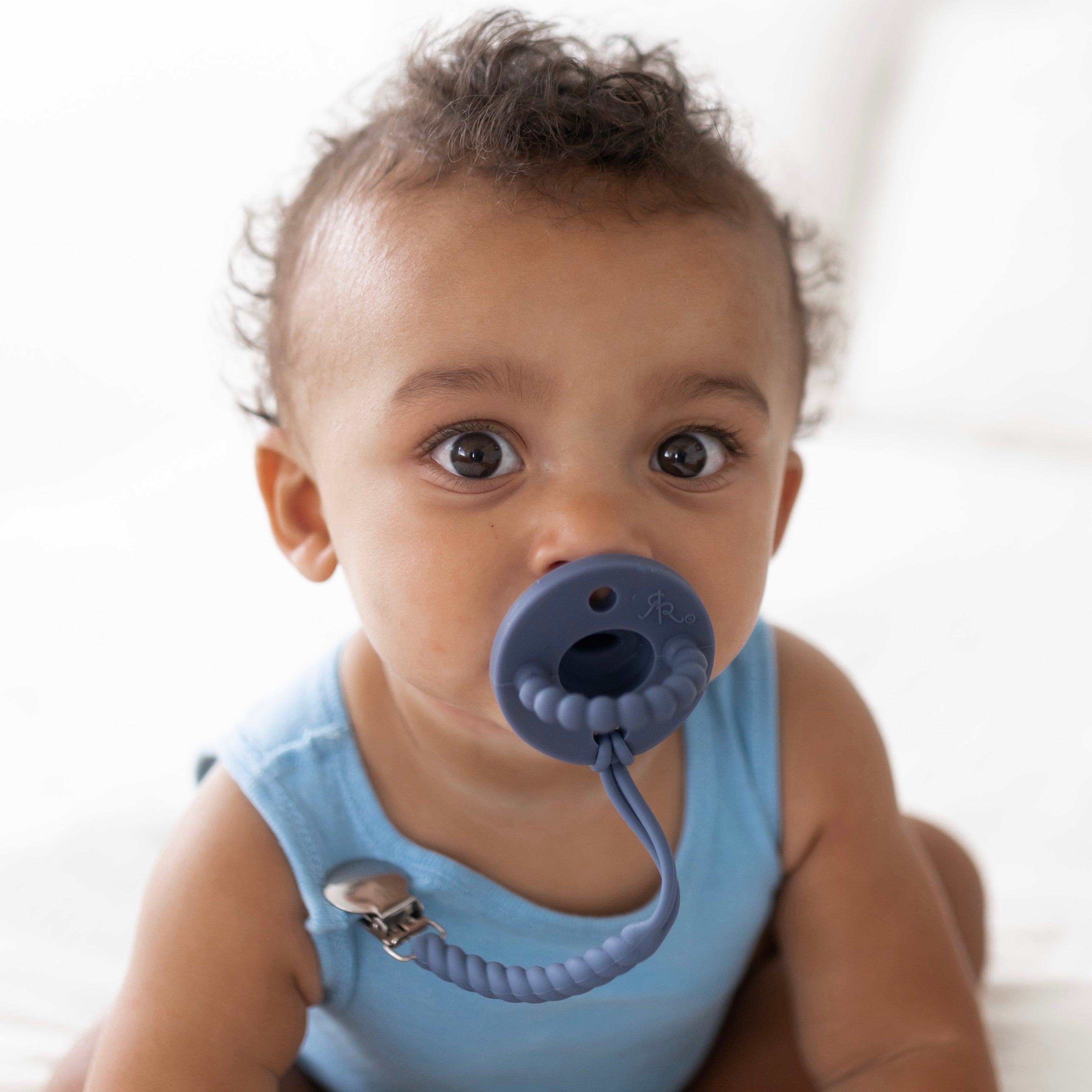 Baby boy wearing a Captain Cutie PAT and Roper Cutie Clip.