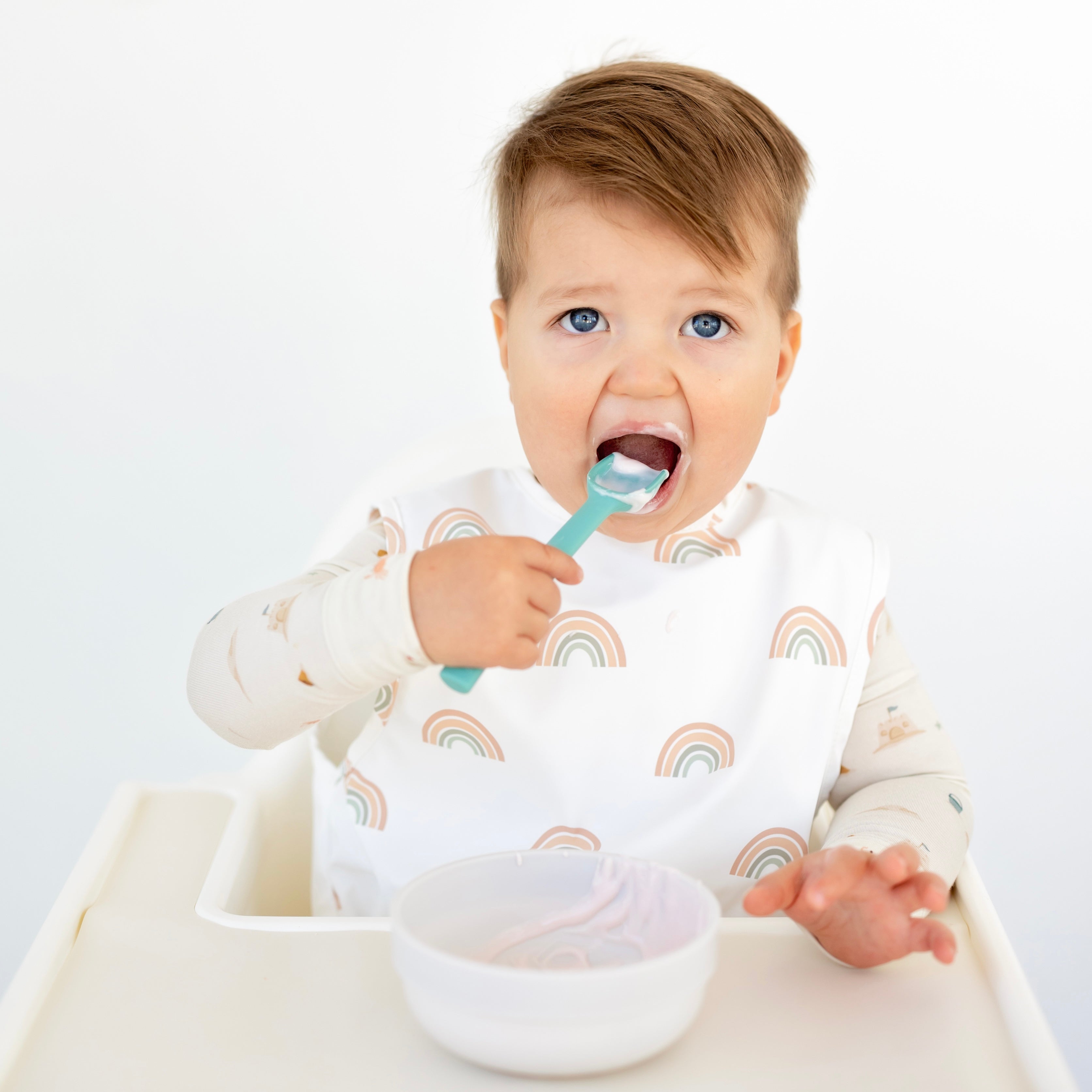 Toddler eating with spoovel