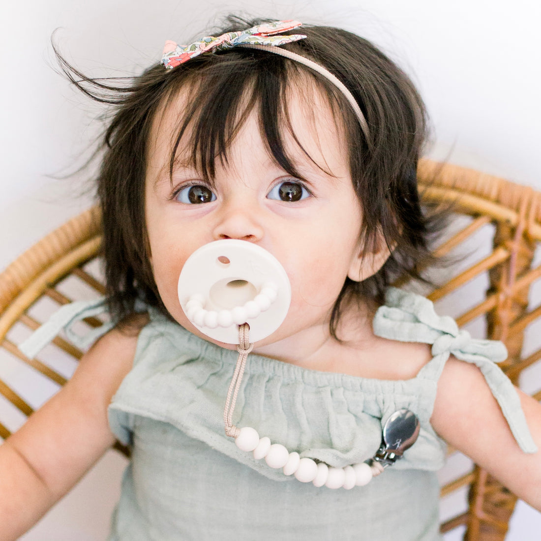 Baby girl using an Ivory Cutie PAT and Olivia Cutie Clip.