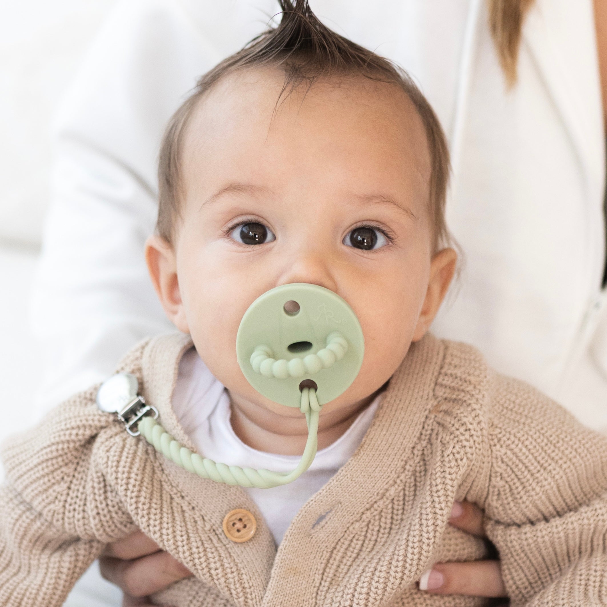 Baby boy wearing a Sage Cutie PAT and Roper Cutie Clip.
