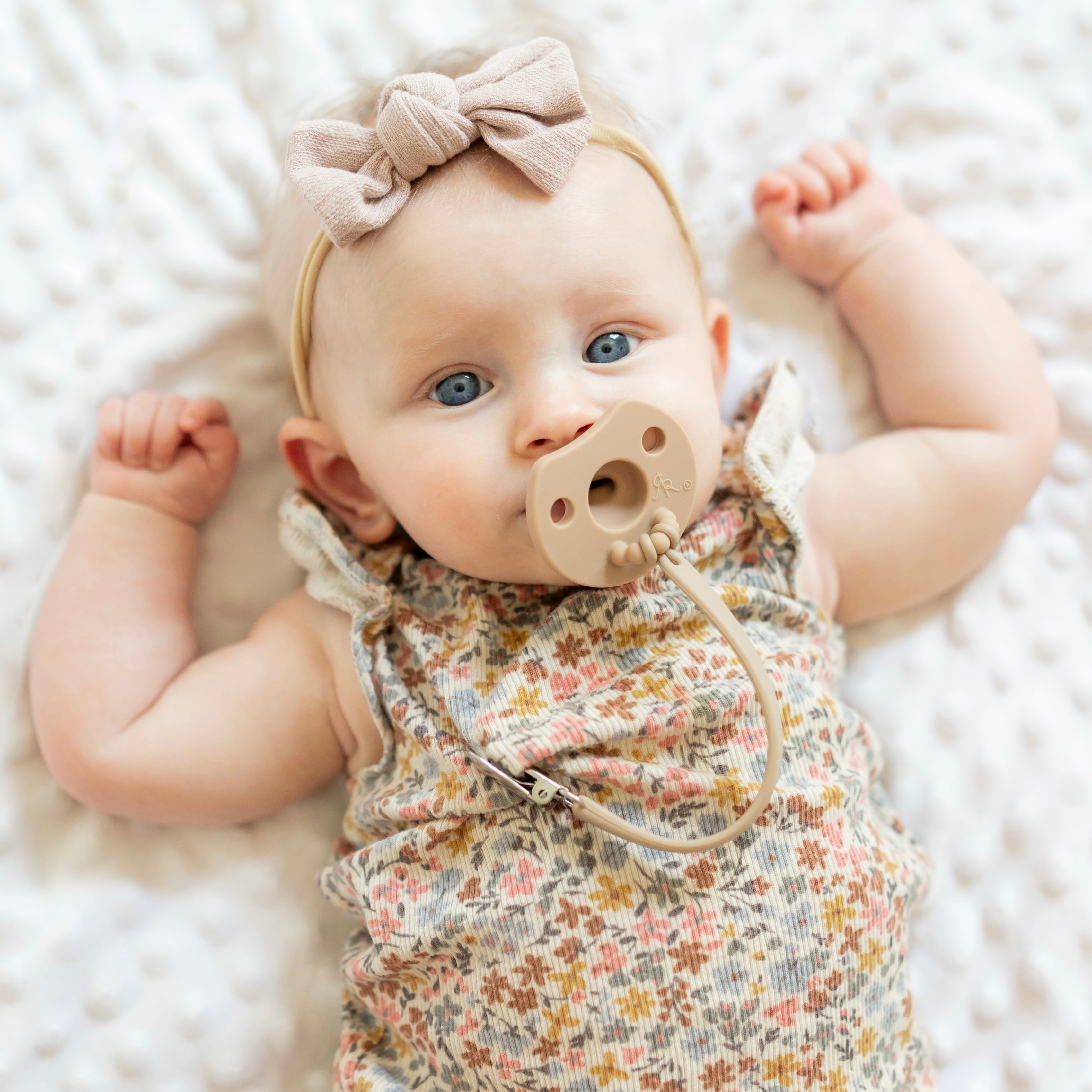 Baby wearing a pacifier and flex clip