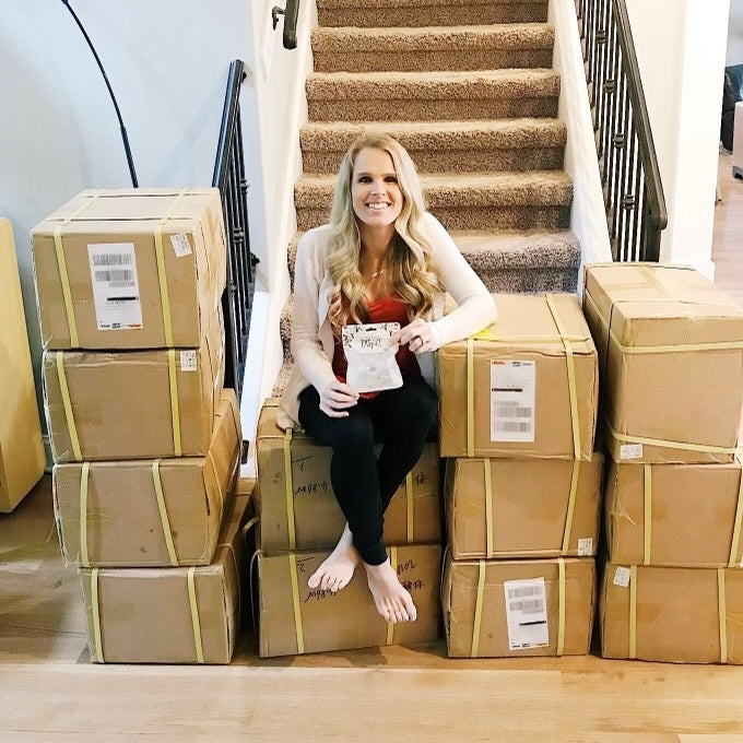 Lindsey surrounded by Cutie PAT boxes