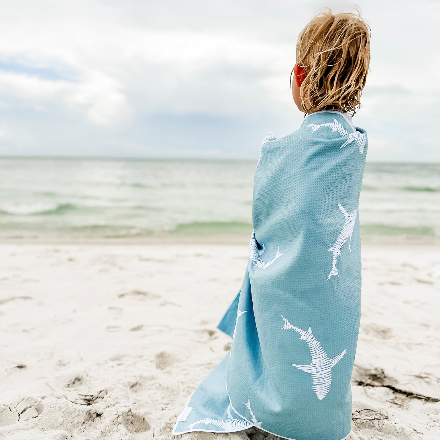 Kid wrapped in beach towel