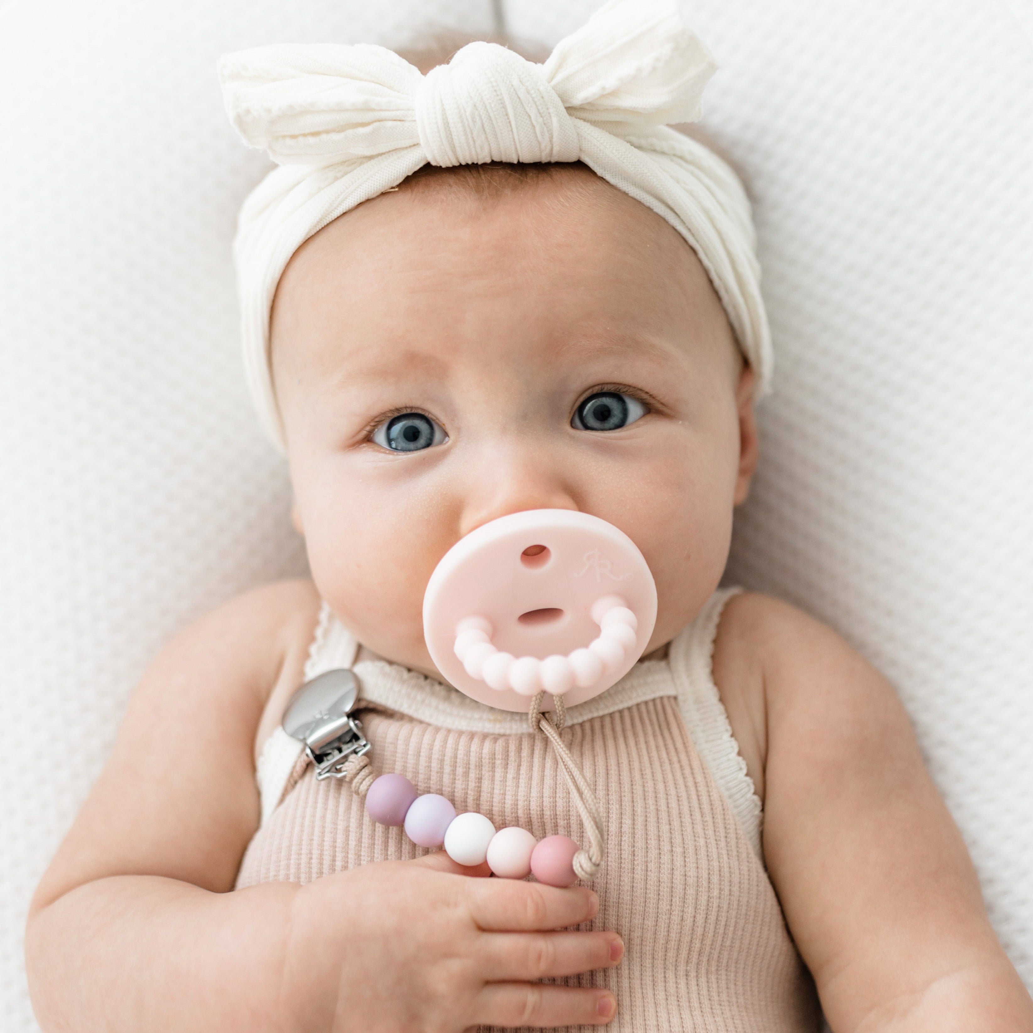 Baby girl wearing a Pink Cutie PAT and Quinn Cutie Clip.