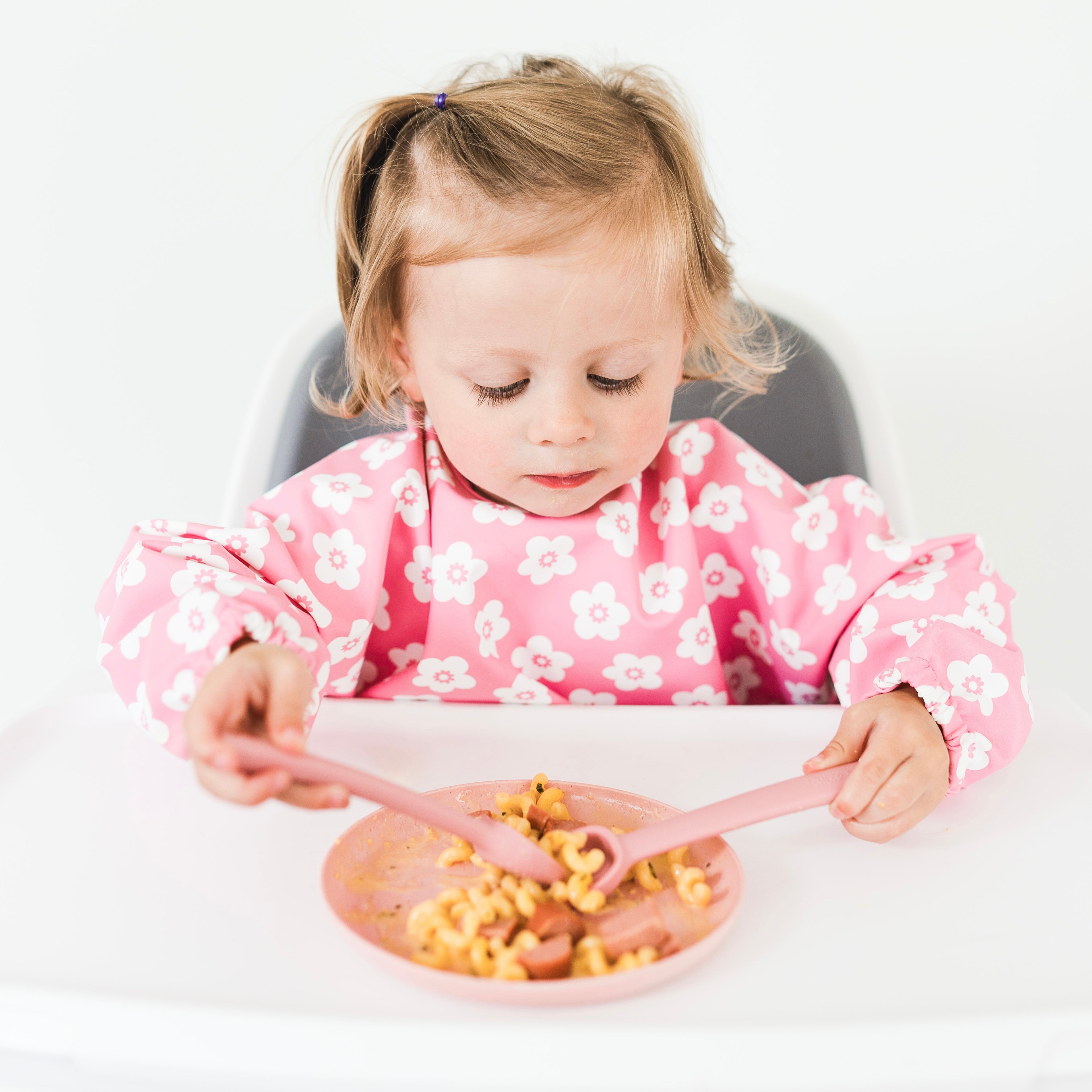 Toddler eating with spoovel