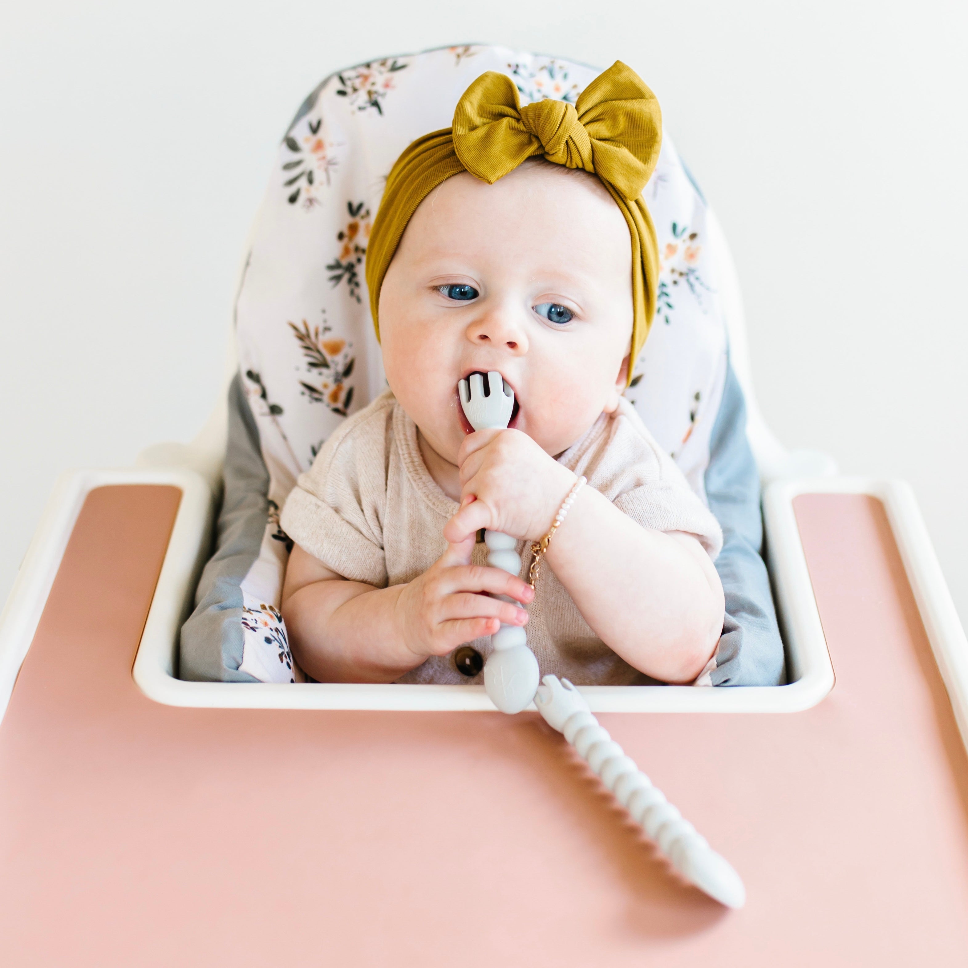 Baby eating with tensils