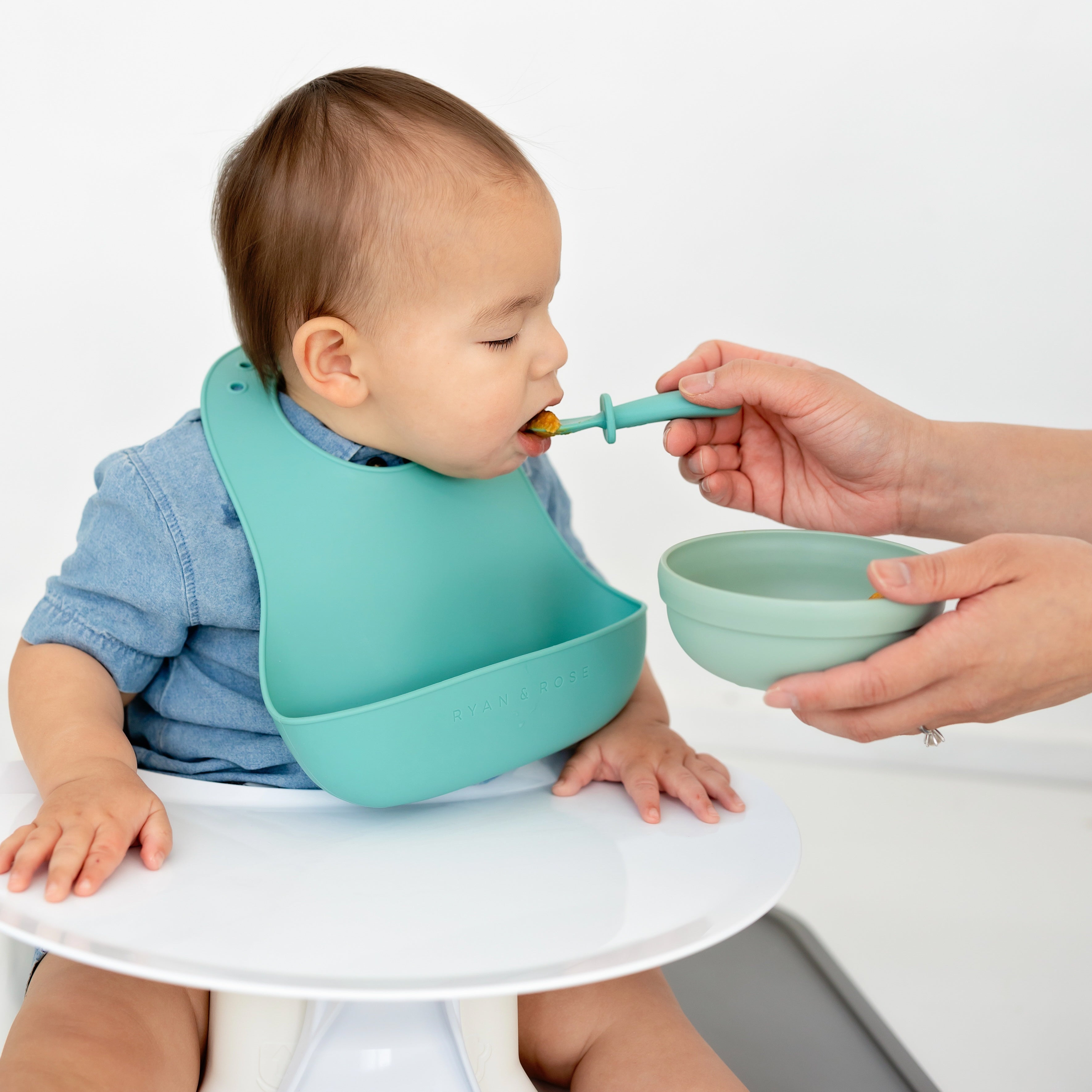 Mom feeding baby with spoonie