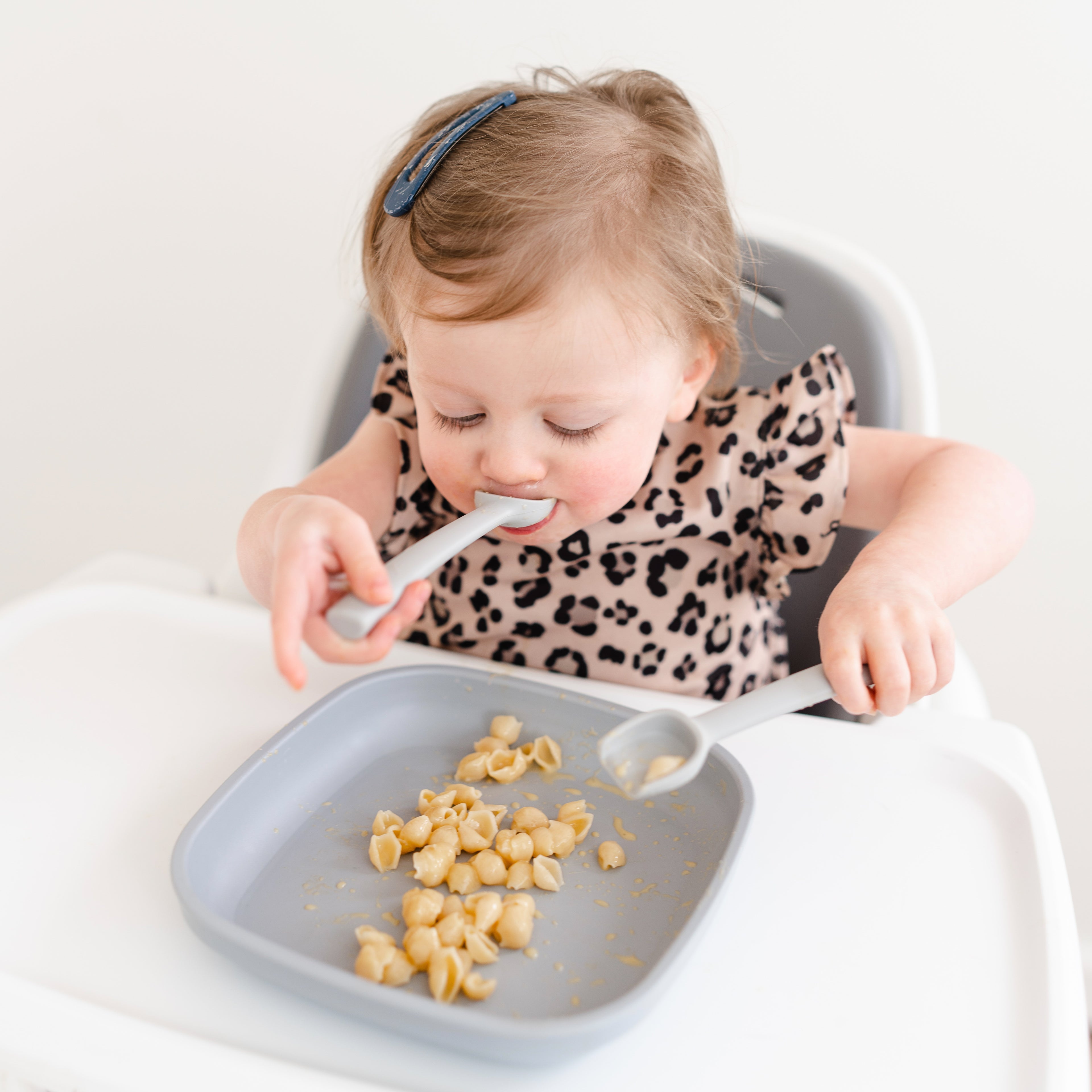 Toddler eating with spoovel