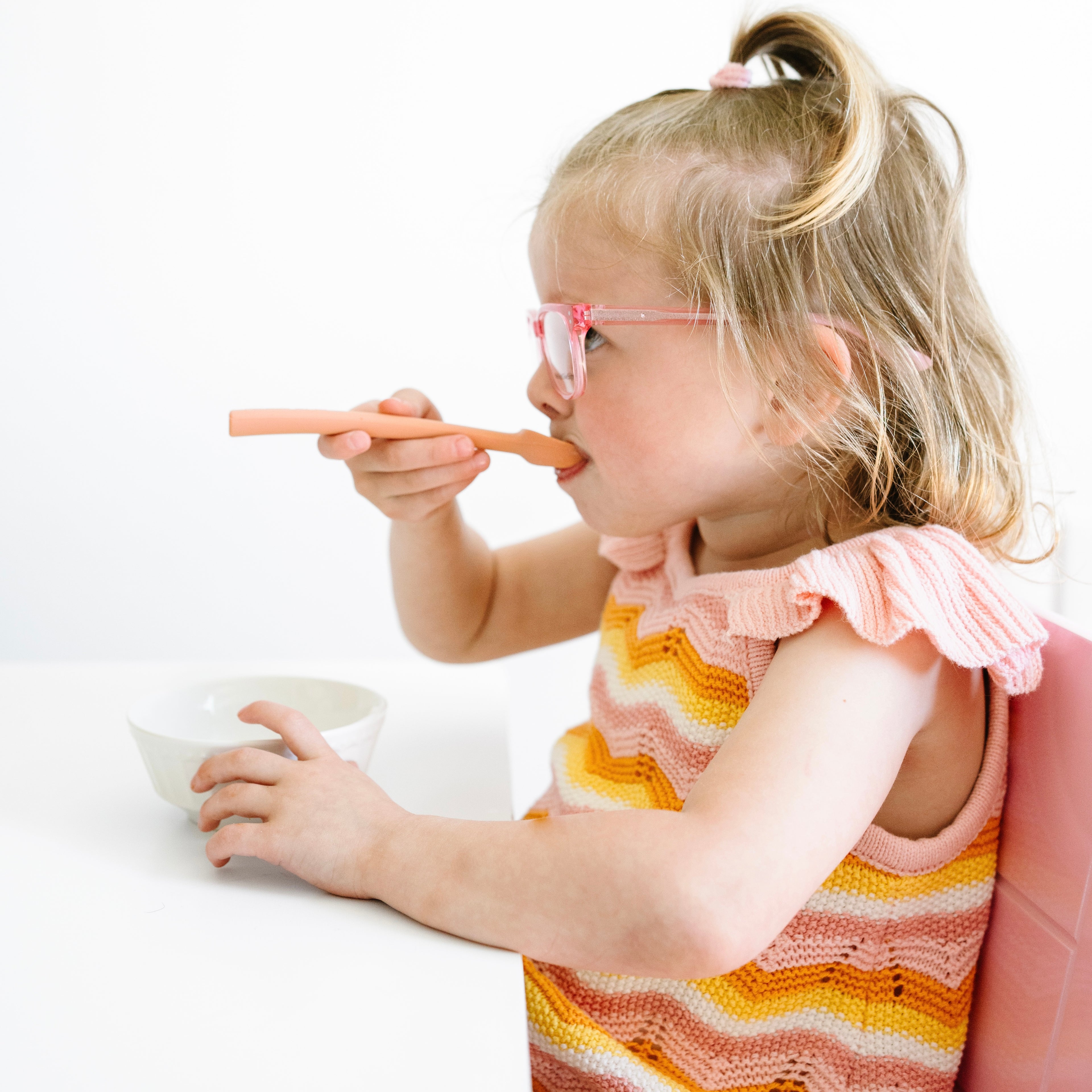 Toddler eating with spoovel