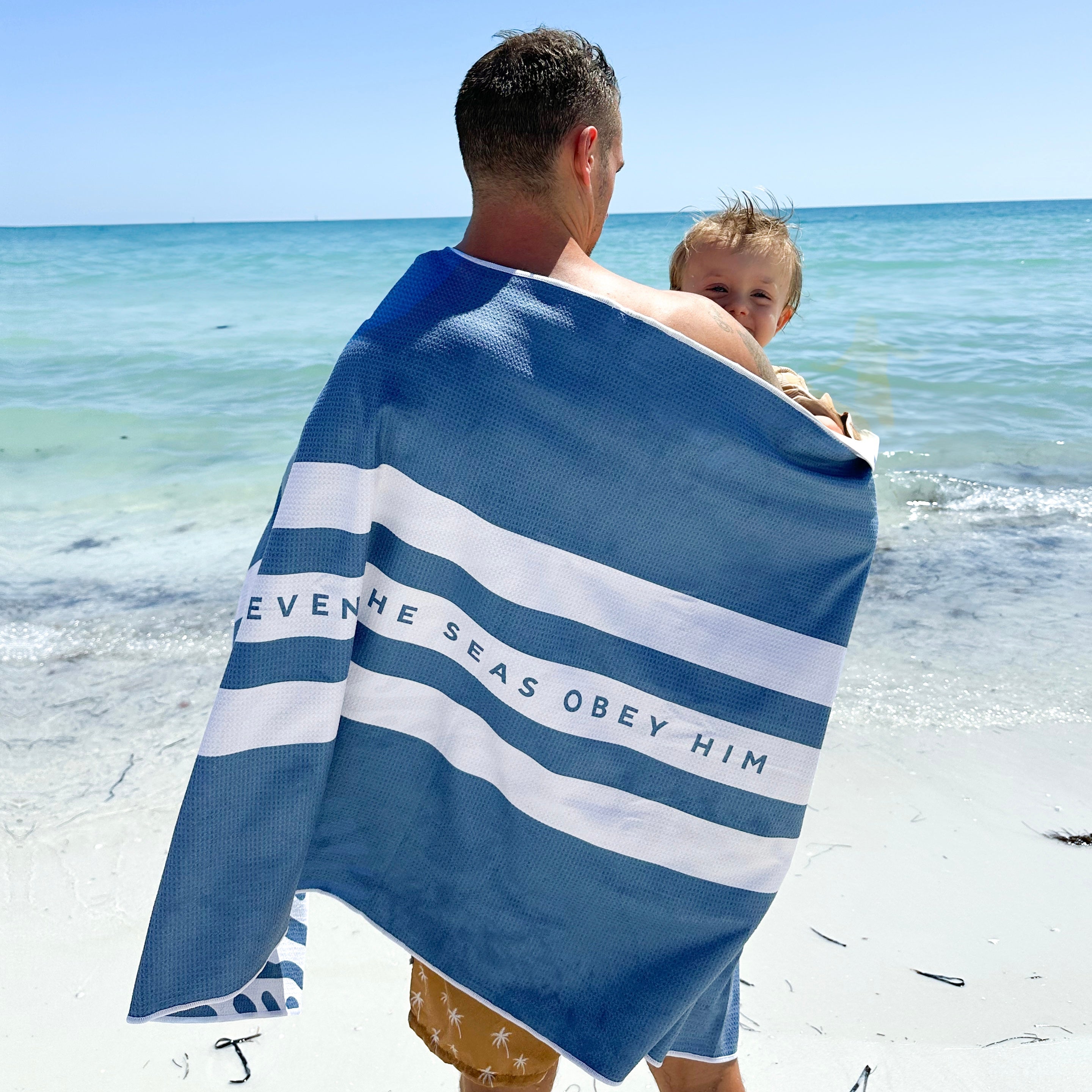 Dad holding kid in towel