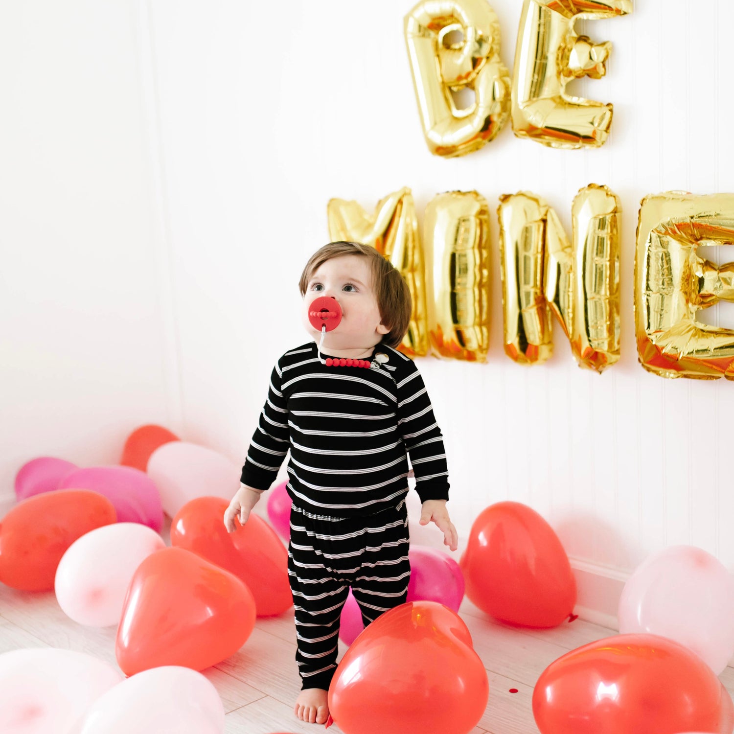 Baby using a Cutie PAT and Cutie Clip in a Valentine set.