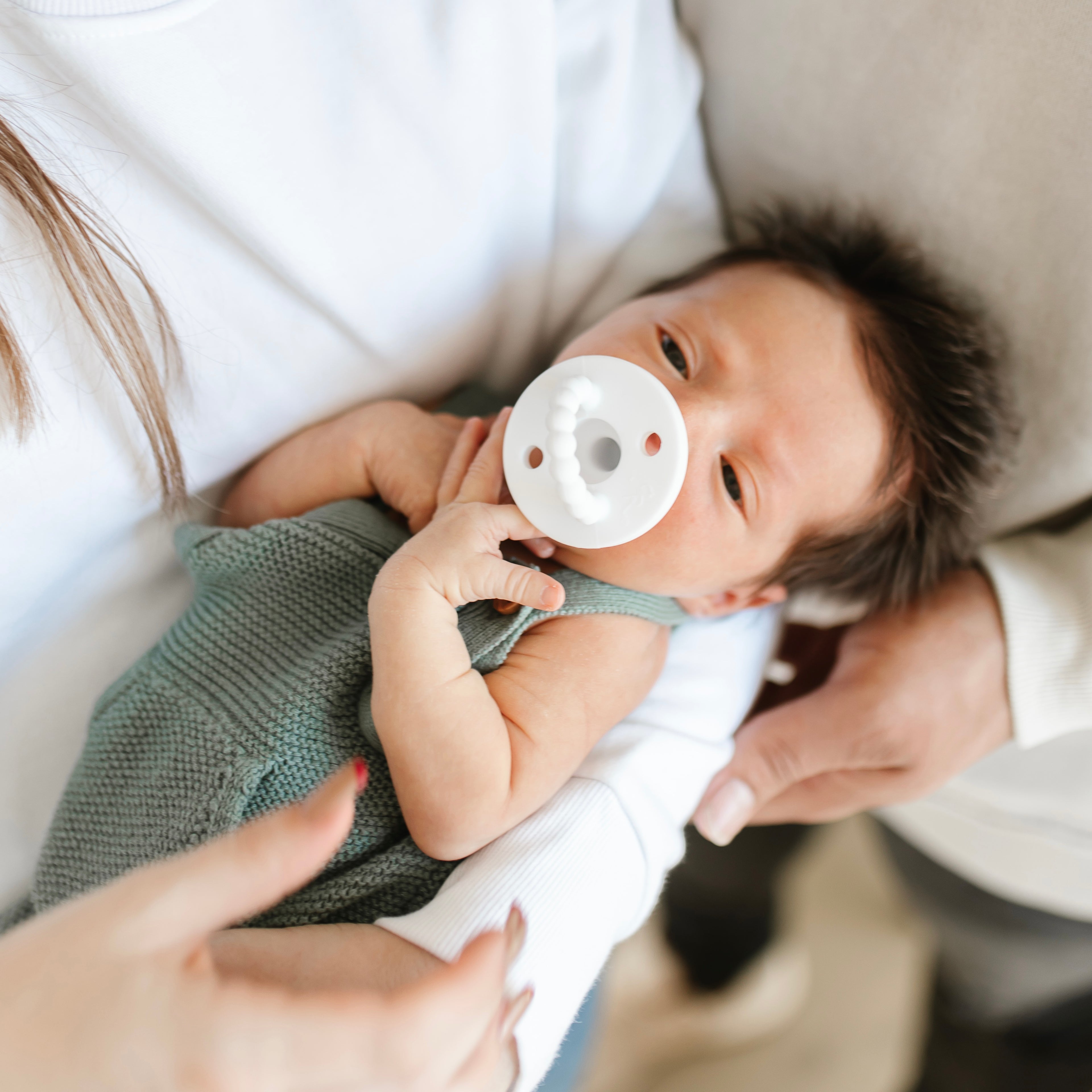 Baby in mom and dad’s arms