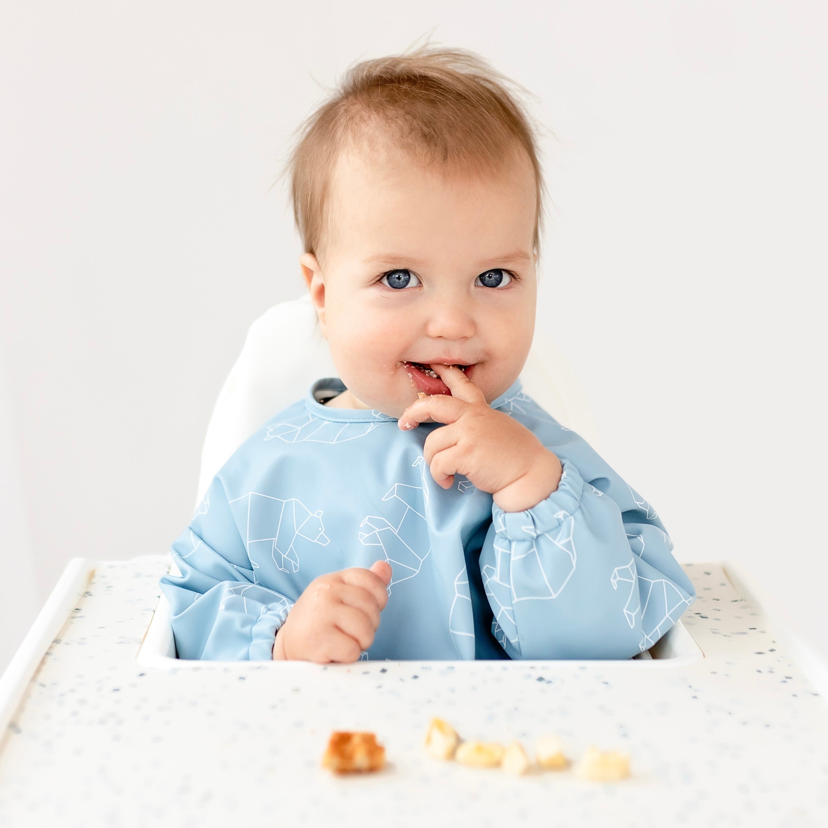 Baby eating in high chair