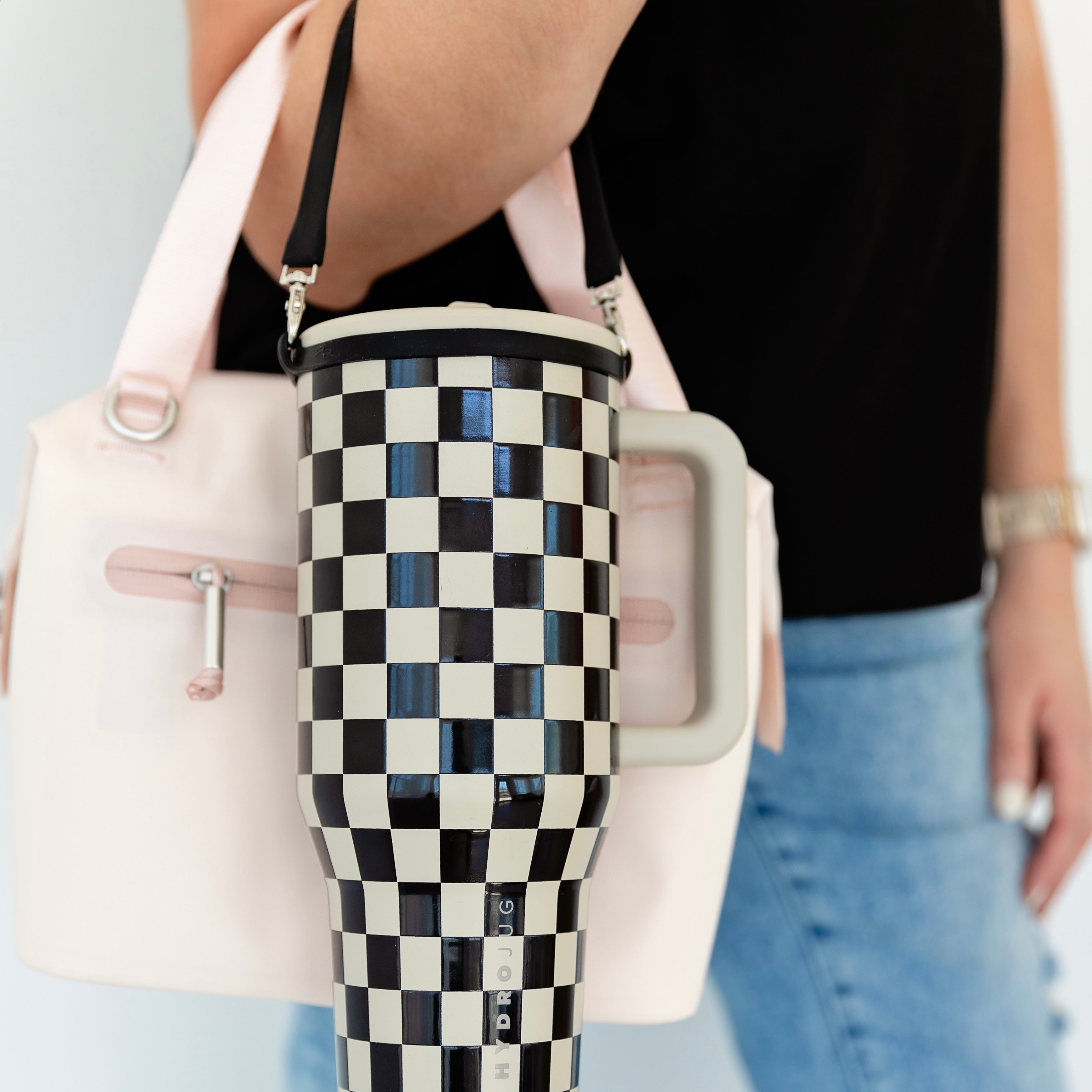Woman holding purse and water bottle