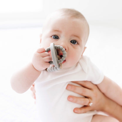 Baby wearing a Cutie Clip attached to the Slate Cutie Bit.