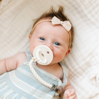Baby using a Roper Ivory Cutie Clip attached to a Cutie PAT Slant.