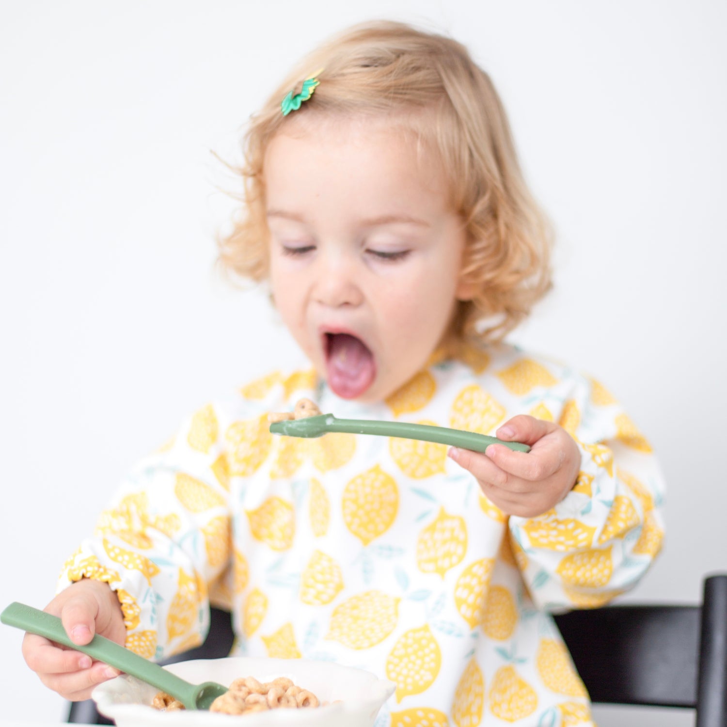 Toddler eating cereal with the Cutie Spoovel.